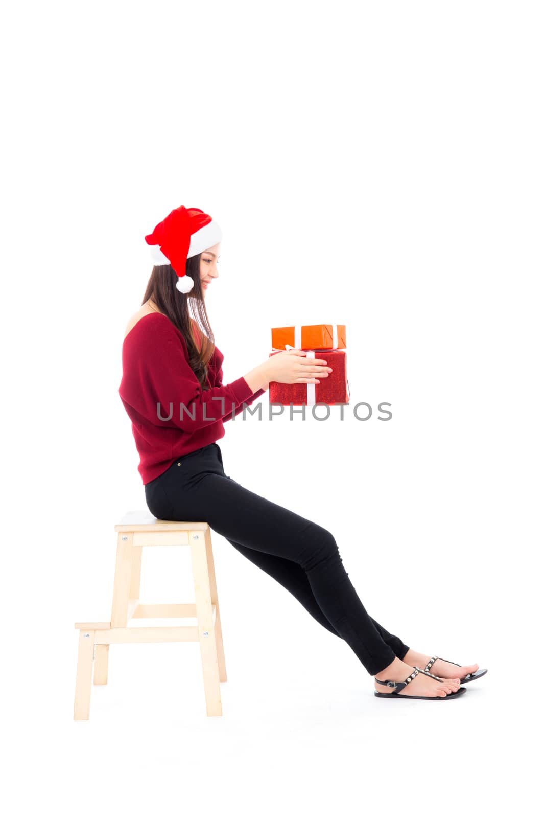 Happy asian woman sitting with smile holding gift box many of xmas, Present girl with celebration christmas a holiday, girl with buyer isolated on white background, shopping concept.