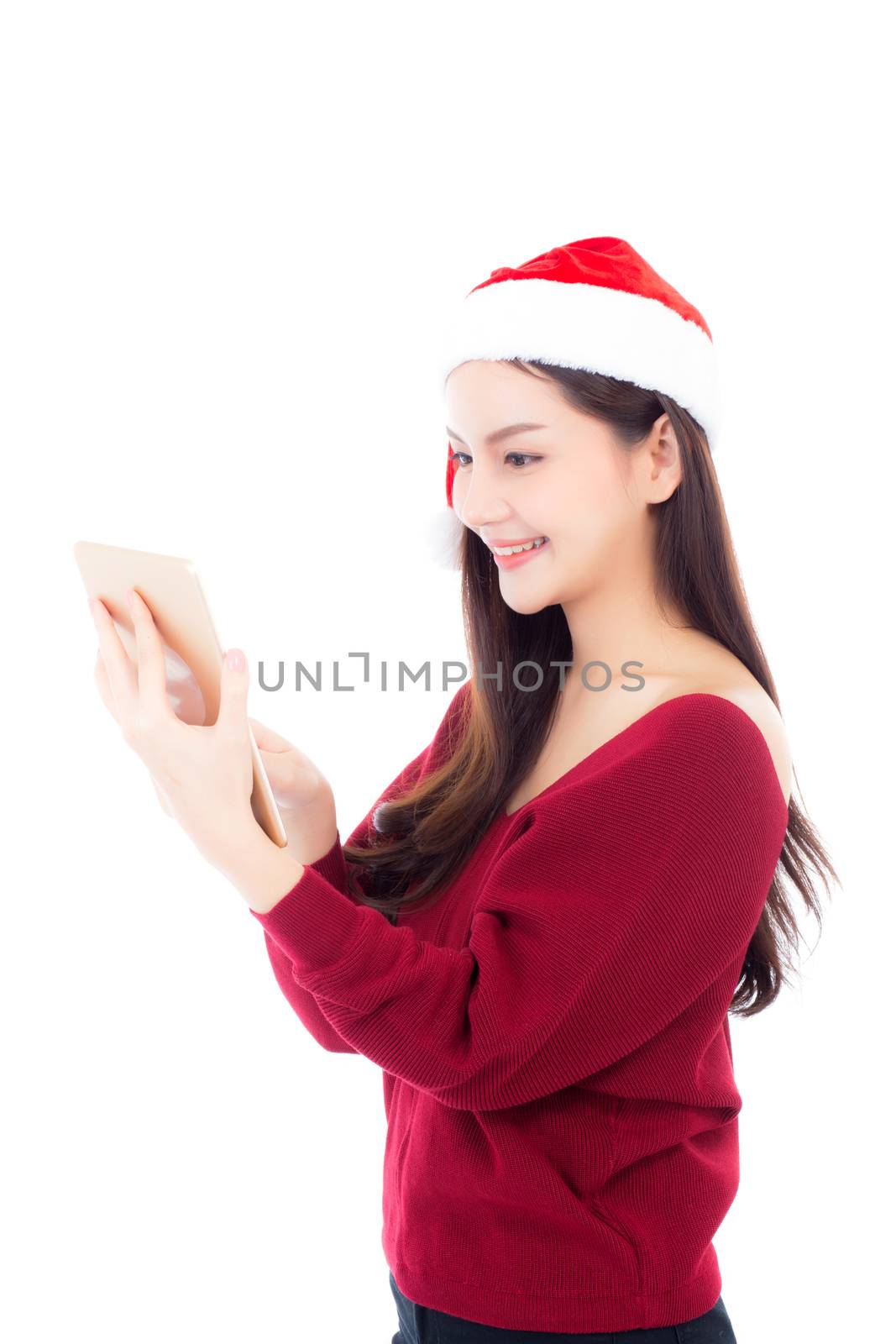 Beautiful young asian woman in red dress with christmas hat hold by nnudoo