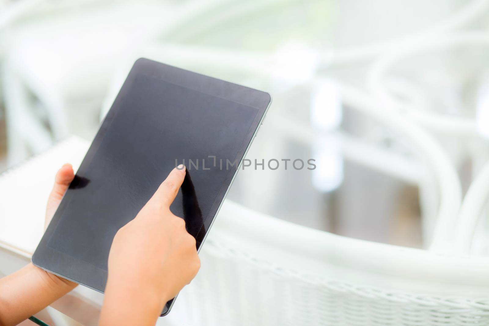 Closeup view of woman holding digital tablet on touch screen device working internet online or open email at office, communication and social networking concept.