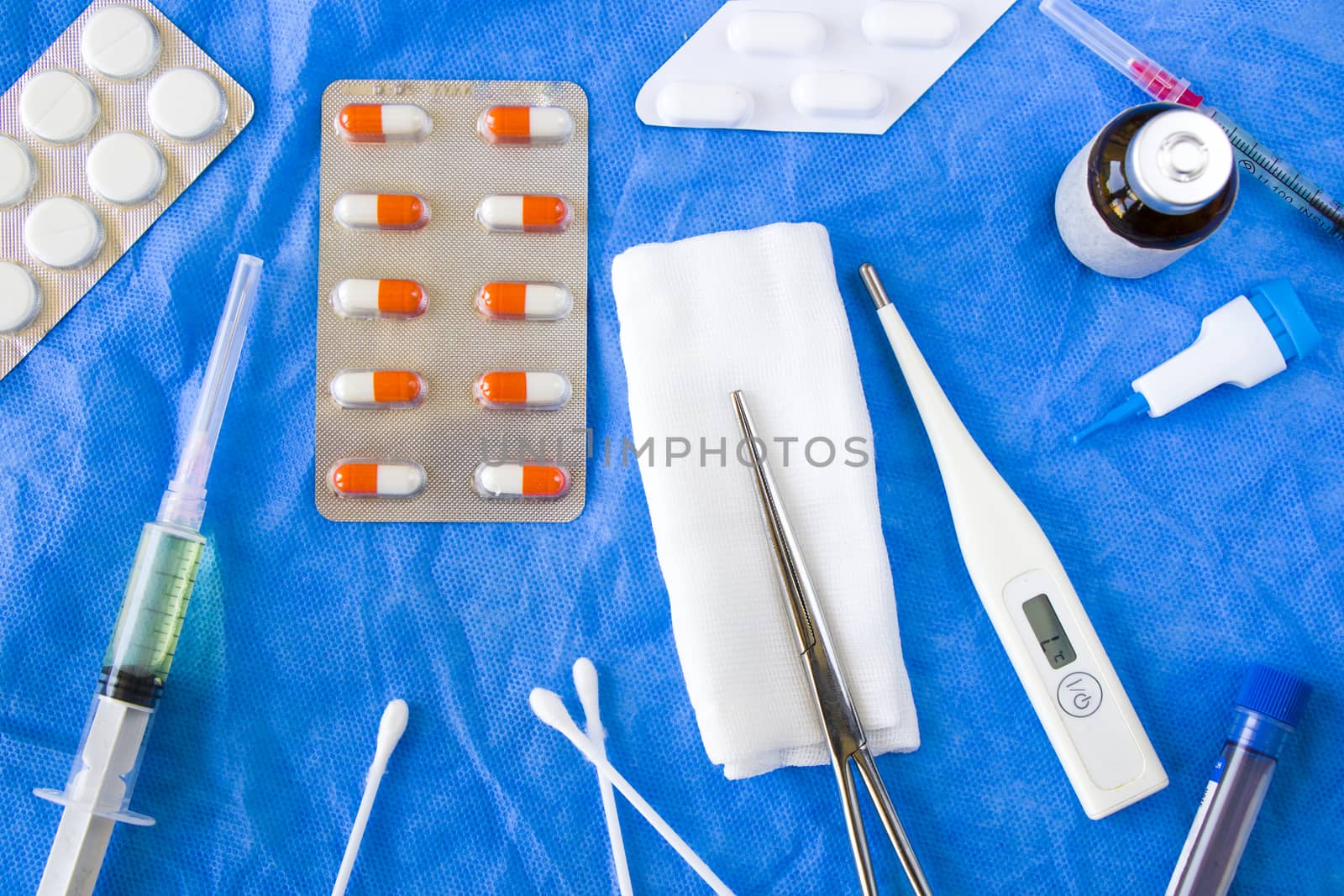 Body thermometer, drugs, needle and ampule on the sterile table, viruses diagnostic by Taidundua