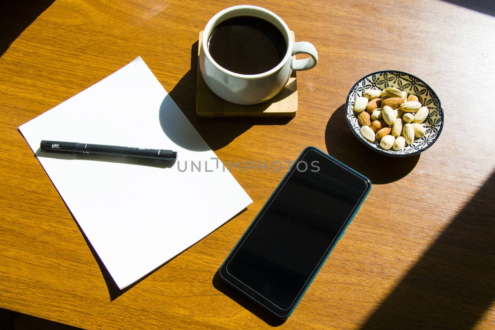 Working from home, workspace with tablet and mobile phone, coffee and workplace. Paper and pen.