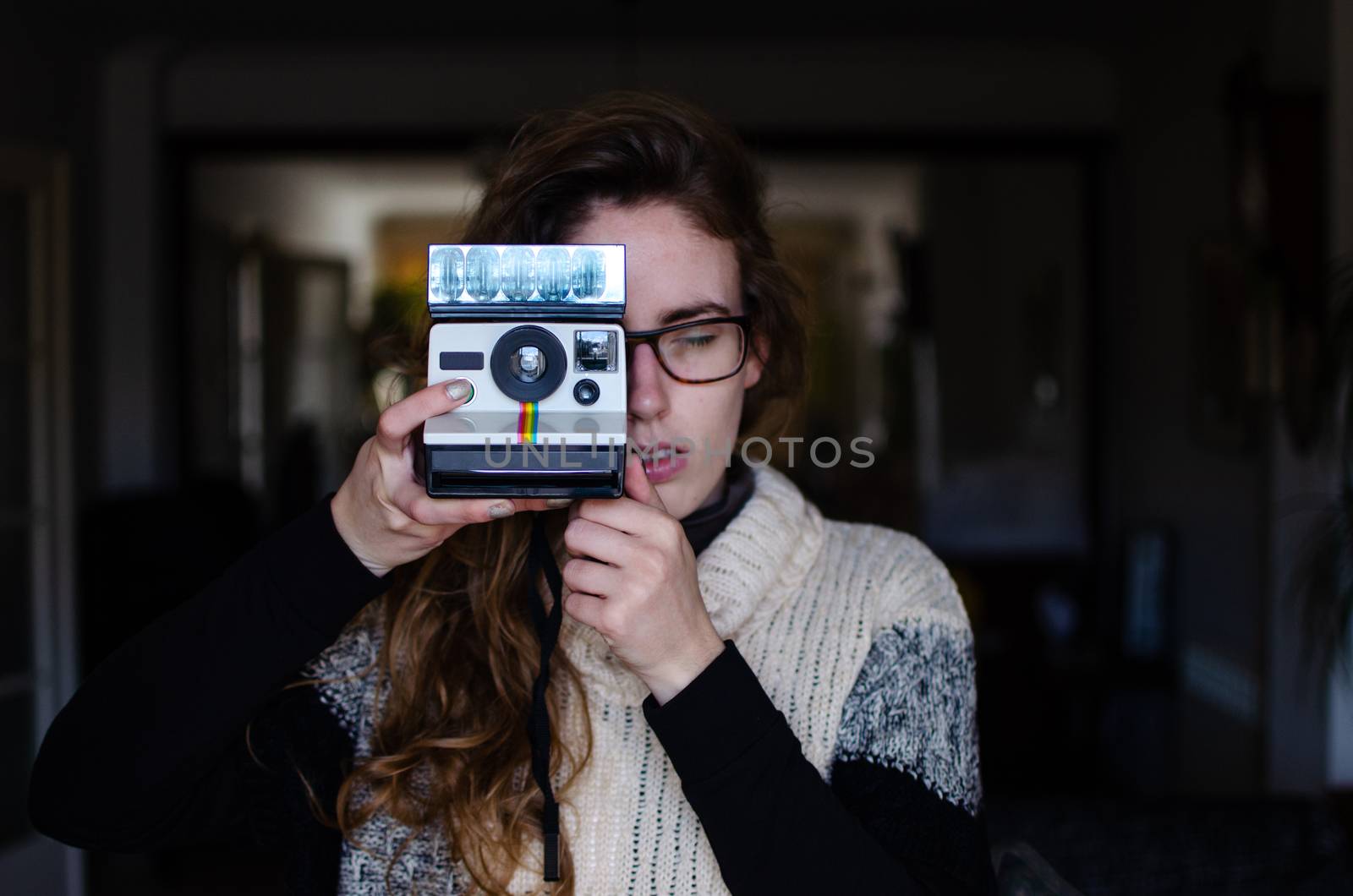 Caucasian girl with dark blond hair with an old automatic printing polaroid camera. by miriamartgraphy