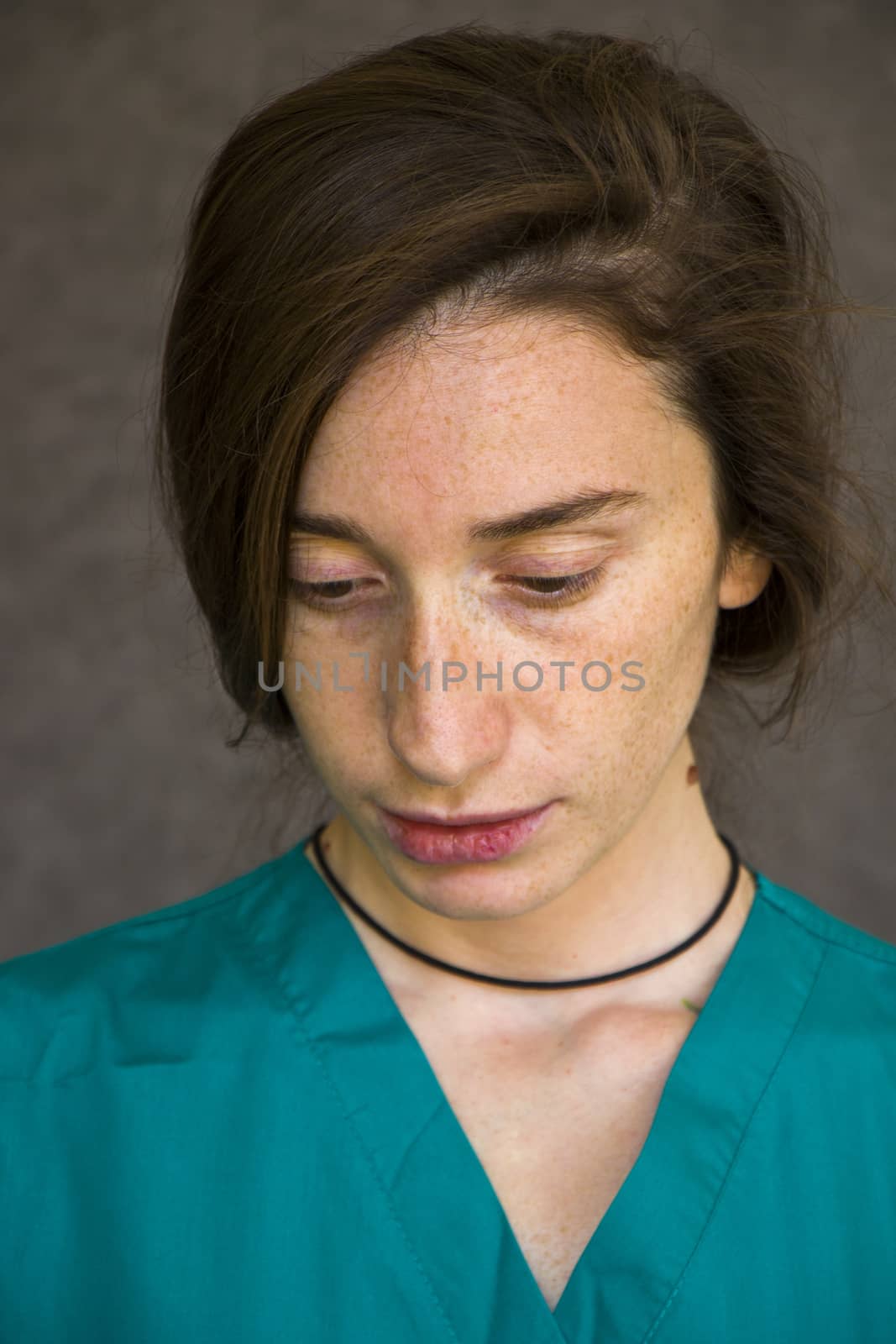 Woman portrait in medical nurse and doctors uniform on the gray background