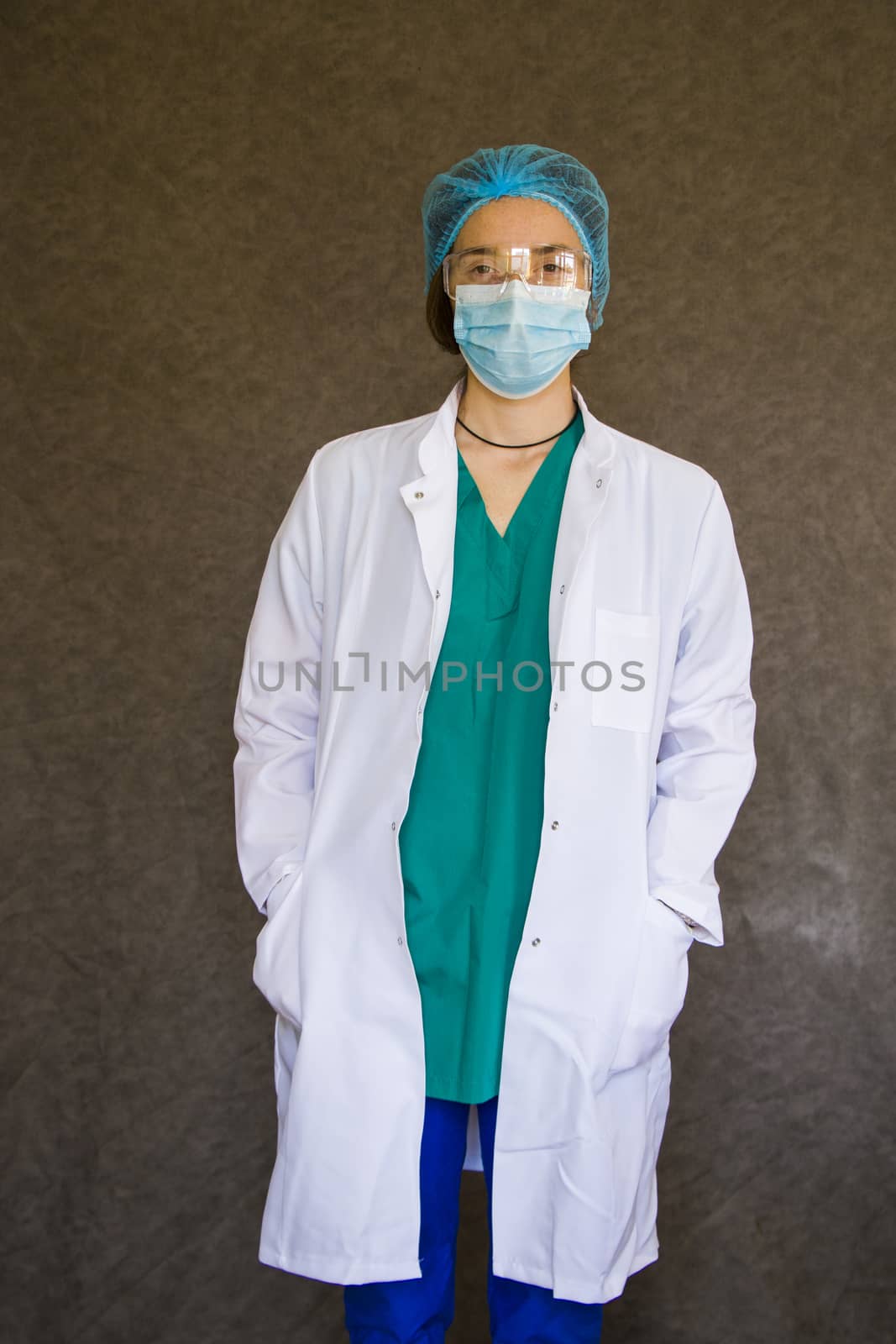 Woman doctors portrait, doctors with mask, glasses, glove and uniform. by Taidundua