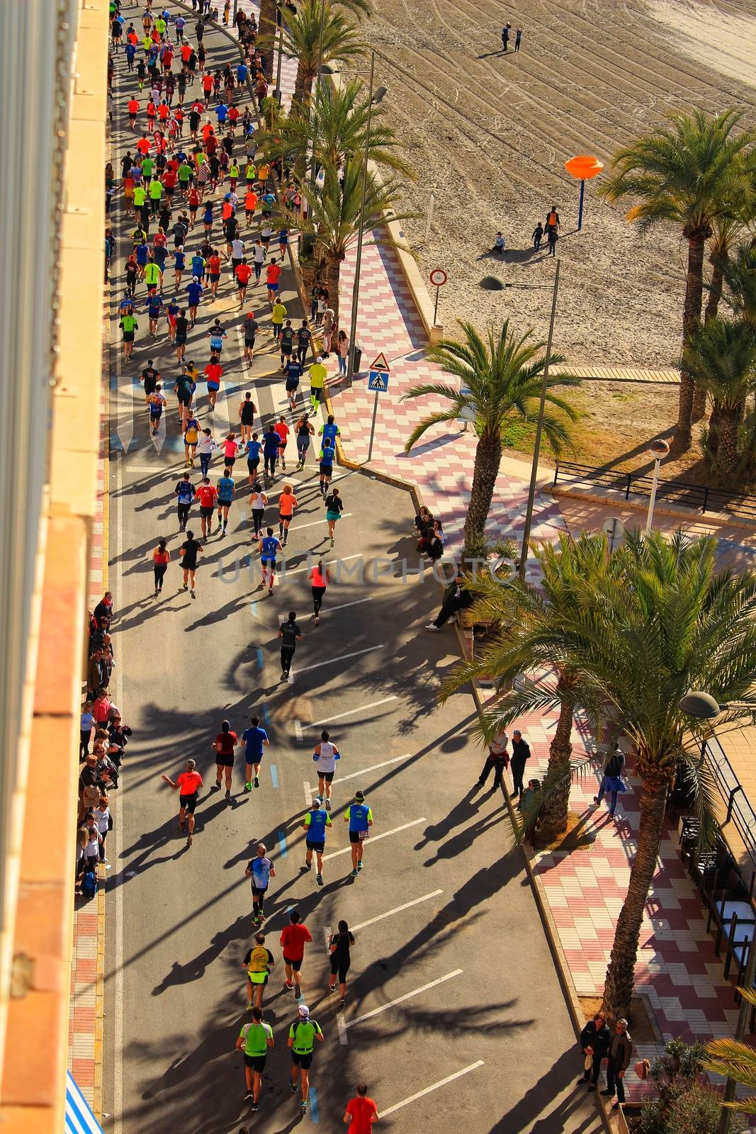Santa Pola, Spain- January 21, 2018: Runners in the Half Marathon of the fishing village of Santa Pola, province of Alicante, on a sunny day in January