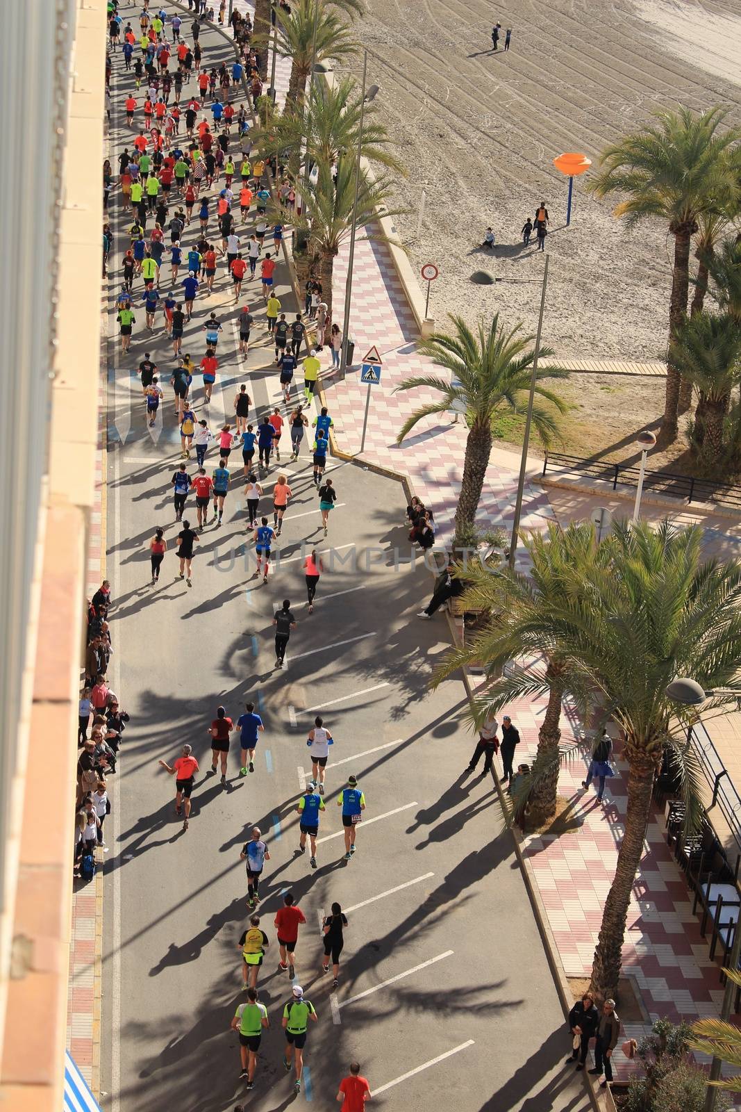 Santa Pola, Spain- January 21, 2018: Runners in the Half Marathon of the fishing village of Santa Pola, province of Alicante, on a sunny day in January