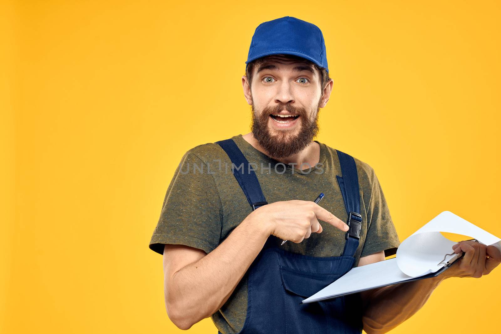 Man in working form documents transportation delivery service yellow background by SHOTPRIME