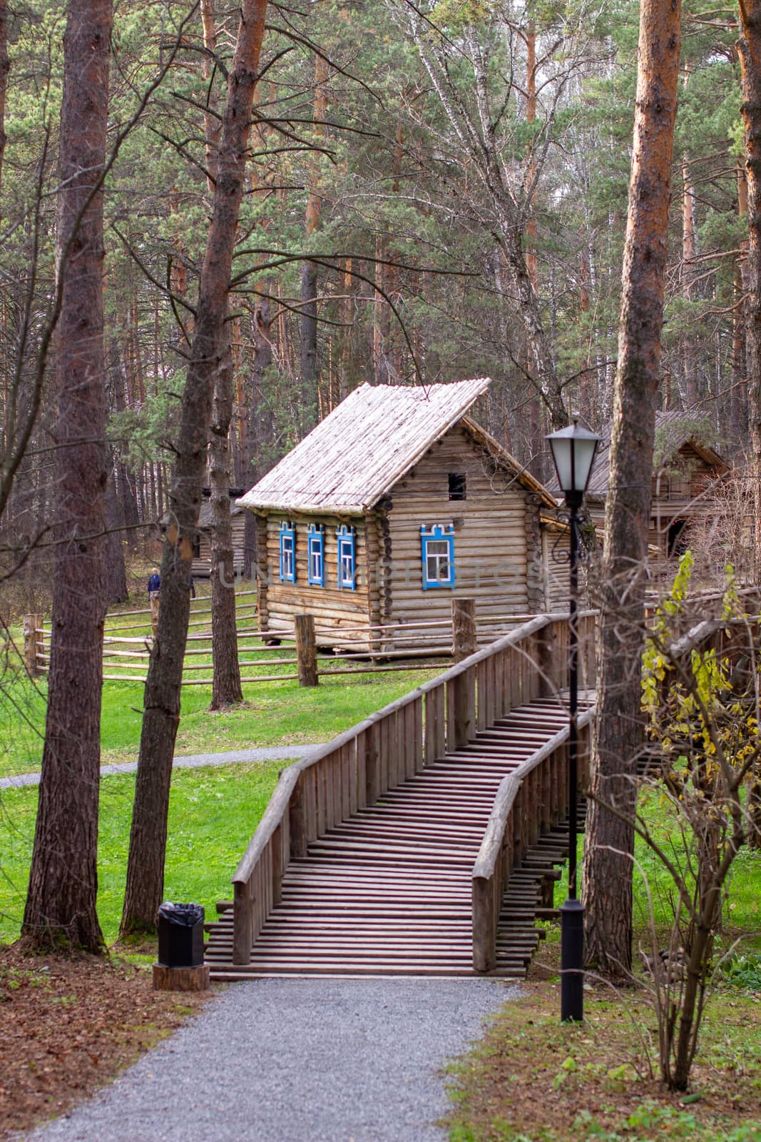 Wooden house with a manor house in the forest.house has painted Window by AnatoliiFoto