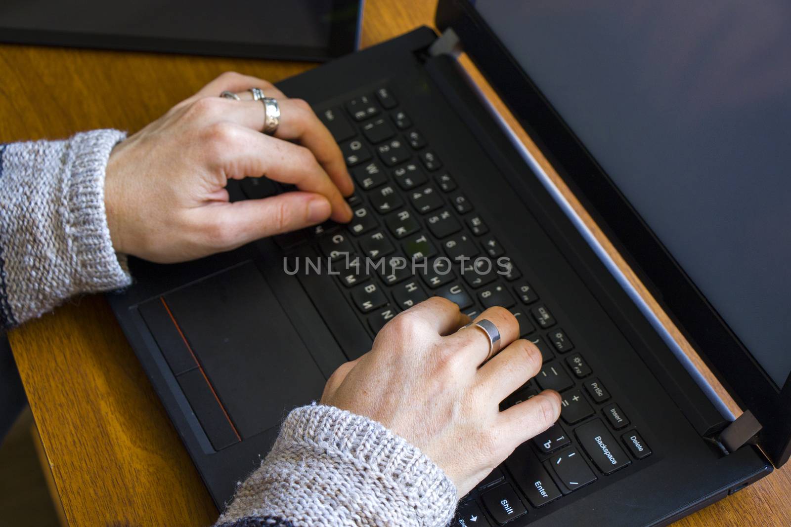 Woman working in office with digital tablet and notebook, writing and typing by Taidundua