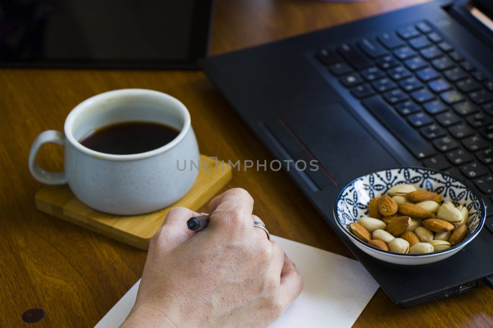 Working process, workspace and workspace, hand, coffee and notebook or laptop by Taidundua