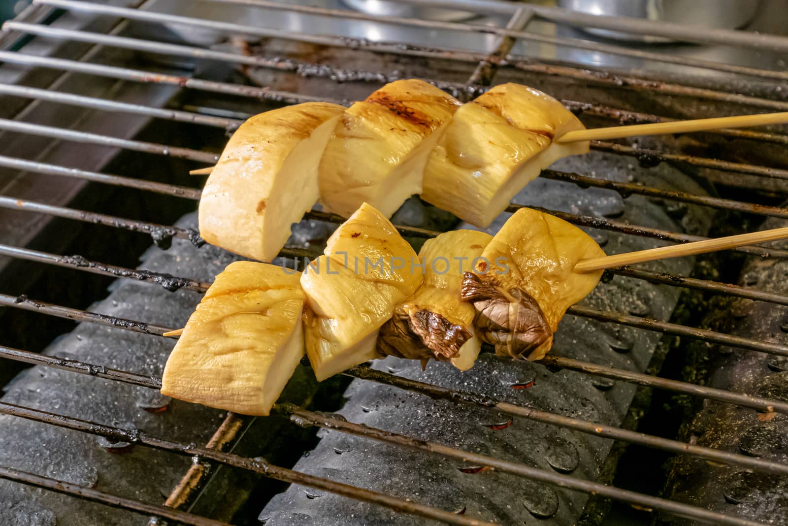 The close up of delicious grilled orinji mushroom at food street night market in Taiwan.