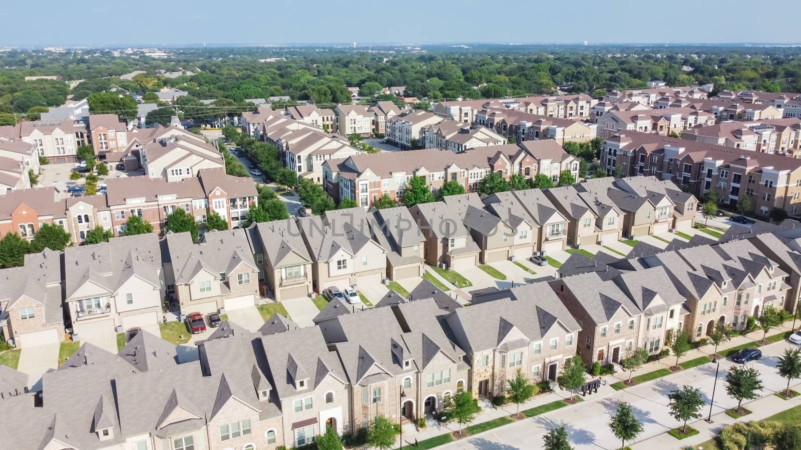 Aerial view of brand new two story condo and townhomes in downtown Flower Mound, Texas, America. Master-planned community and census-designated residential houses and apartment buildings