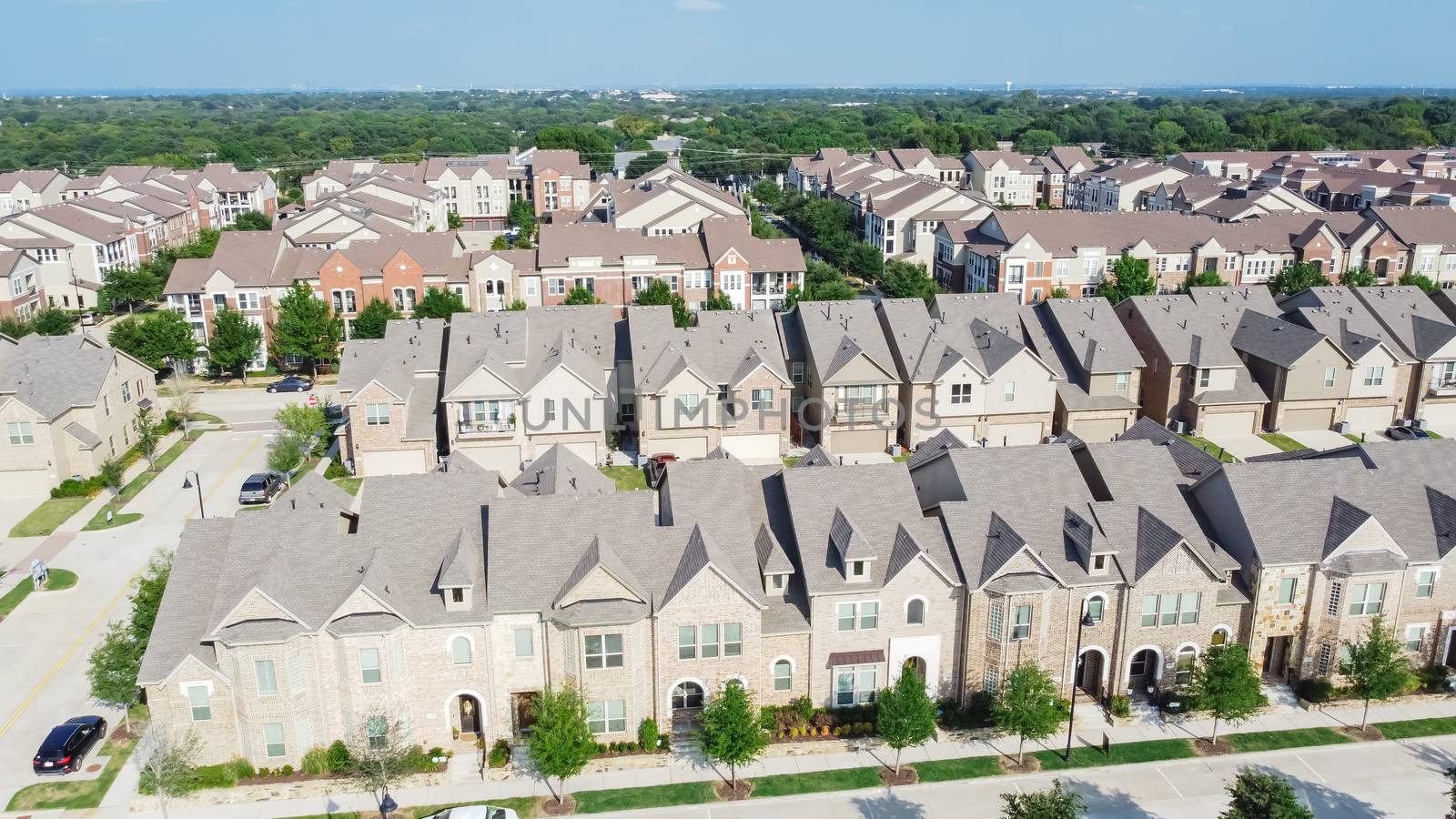 Aerial view of brand new two story condo and townhomes in downtown Flower Mound, Texas, America. Master-planned community and census-designated residential houses and apartment buildings
