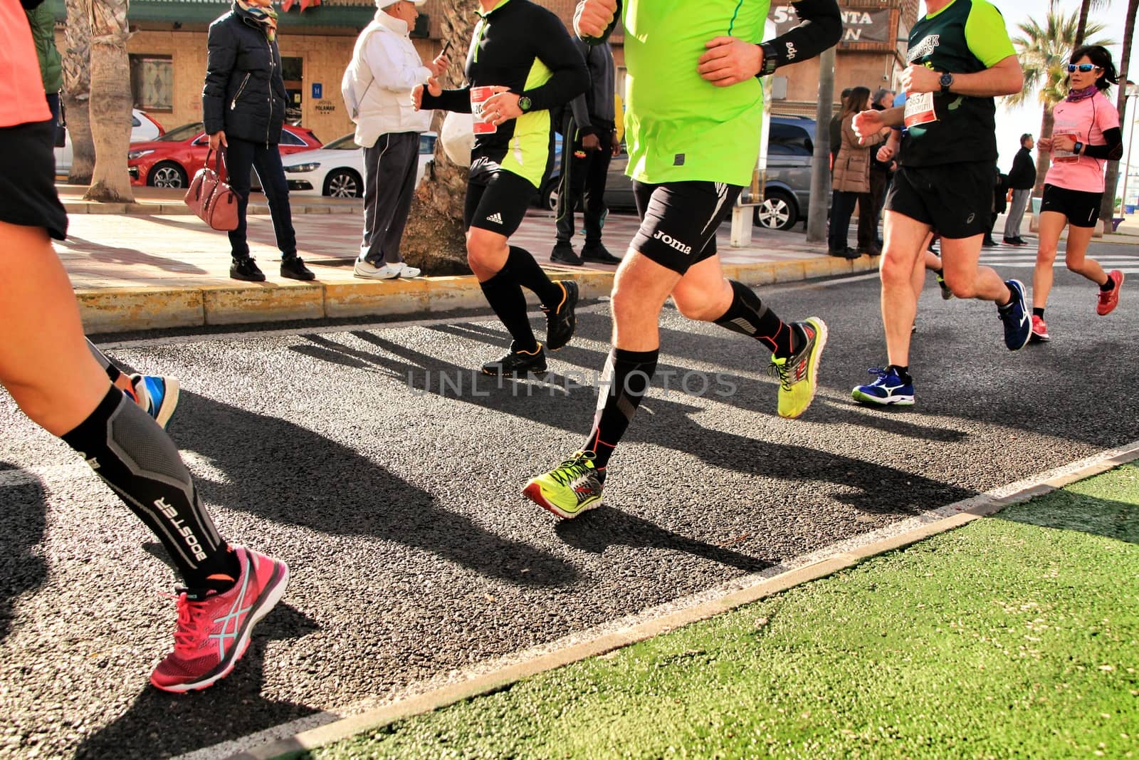 Santa Pola, Spain- January 20, 2019: Runners in the Half Marathon of the fishing village of Santa Pola, province of Alicante, on a sunny day in January