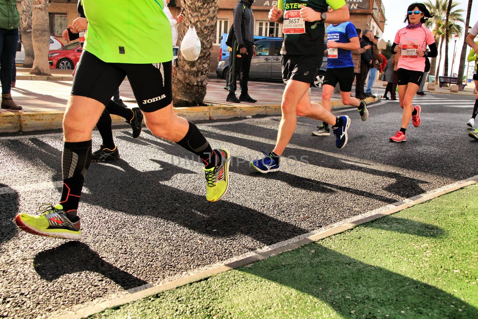 Santa Pola, Spain- January 20, 2019: Runners in the Half Marathon of the fishing village of Santa Pola, province of Alicante, on a sunny day in January