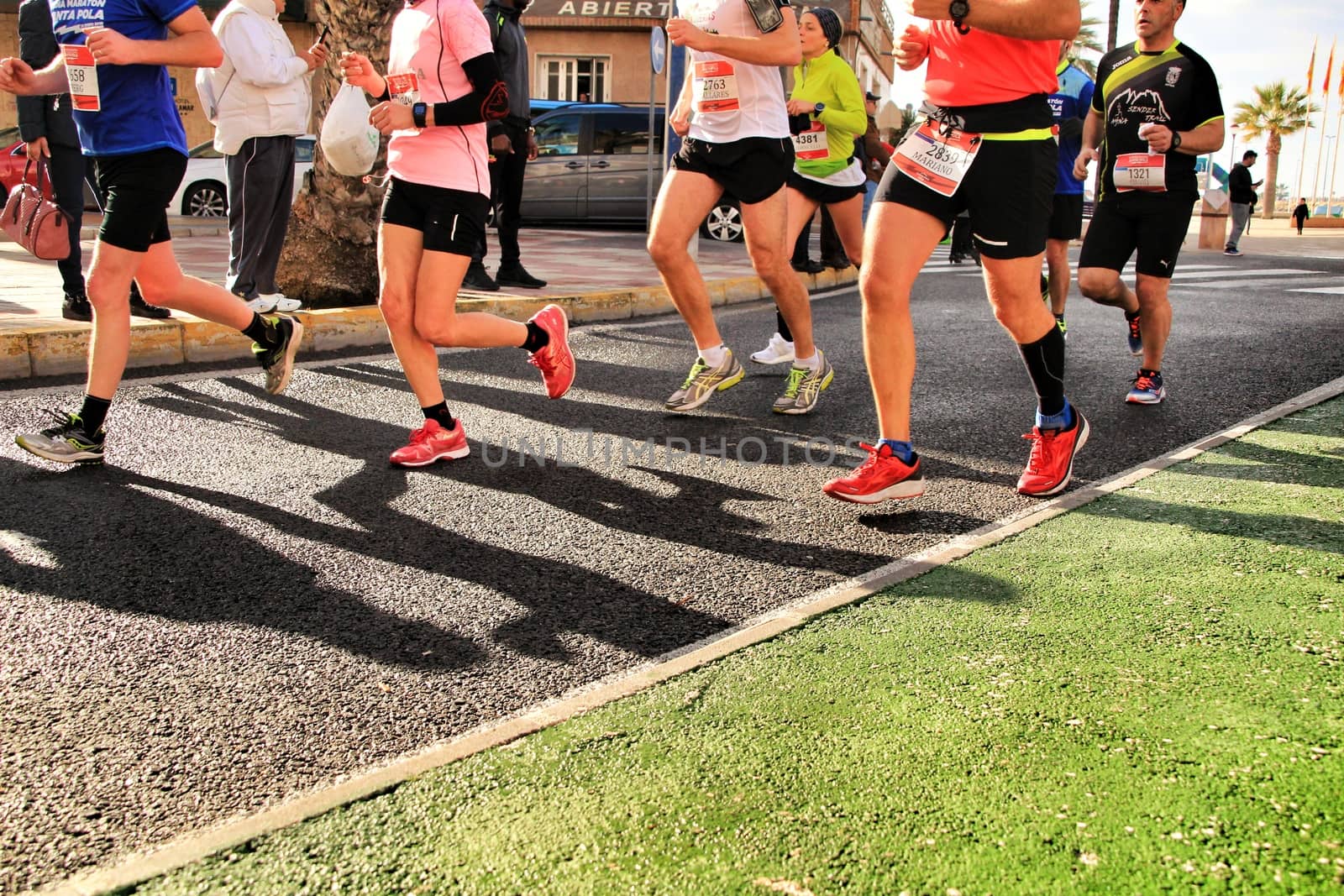 Santa Pola, Spain- January 20, 2019: Runners in the Half Marathon of the fishing village of Santa Pola, province of Alicante, on a sunny day in January