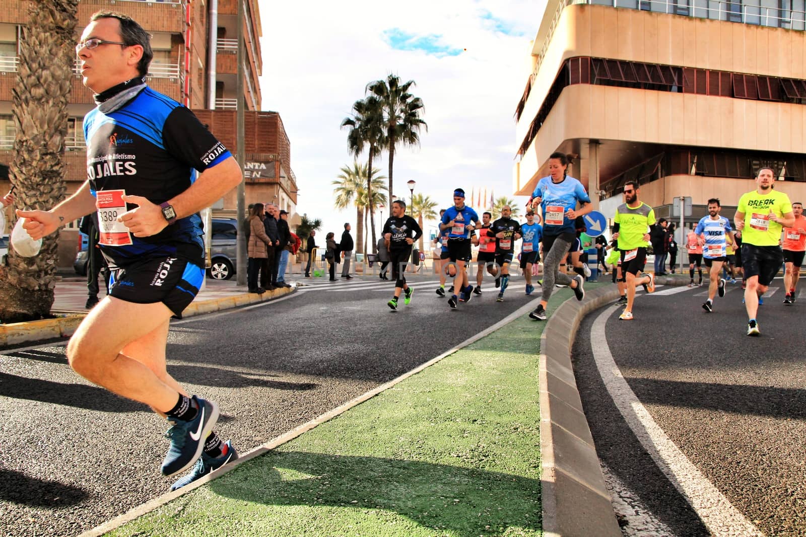 Santa Pola, Spain- January 20, 2019: Runners in the Half Marathon of the fishing village of Santa Pola, province of Alicante, on a sunny day in January
