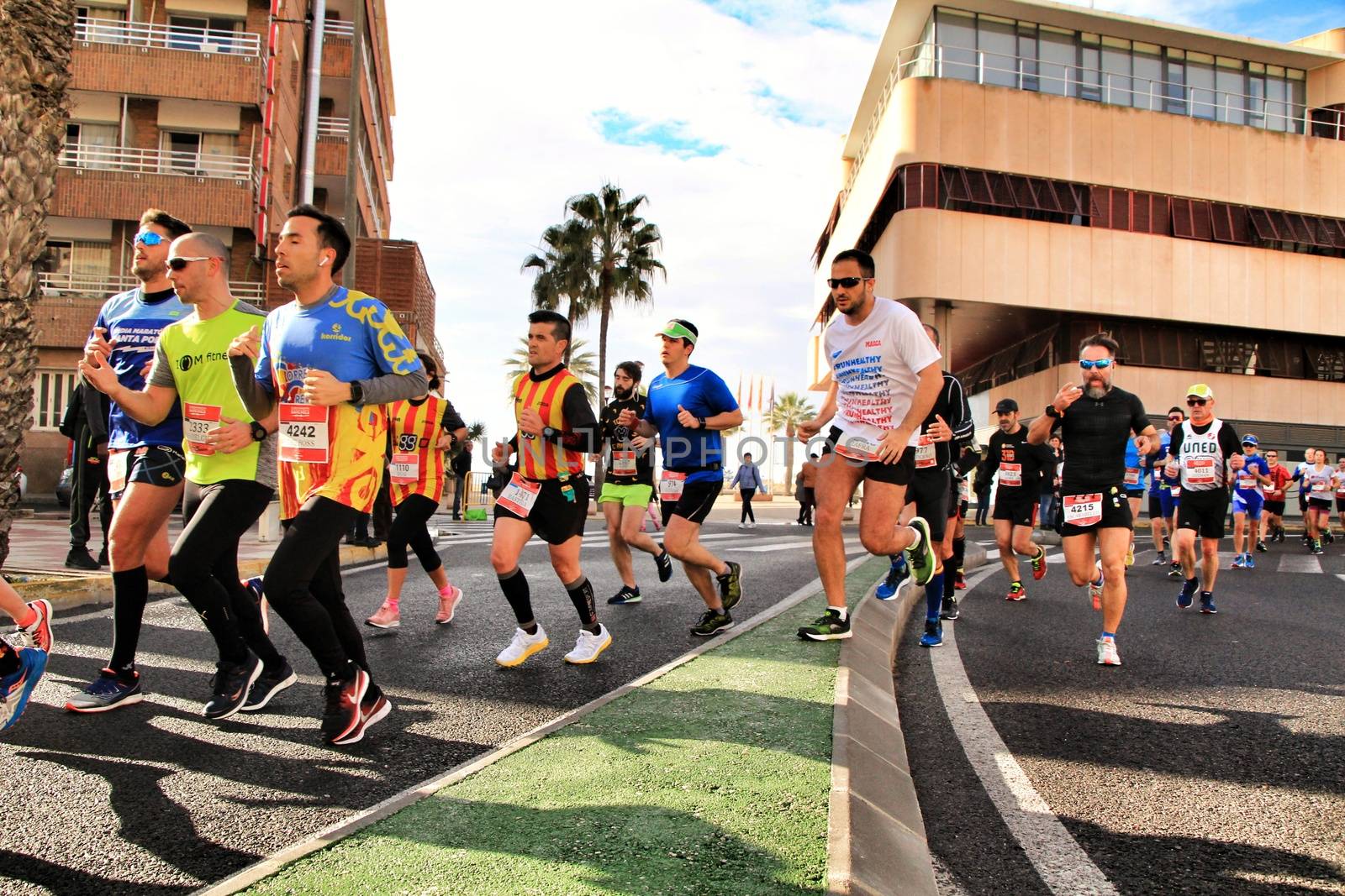 Santa Pola, Spain- January 20, 2019: Runners in the Half Marathon of the fishing village of Santa Pola, province of Alicante, on a sunny day in January