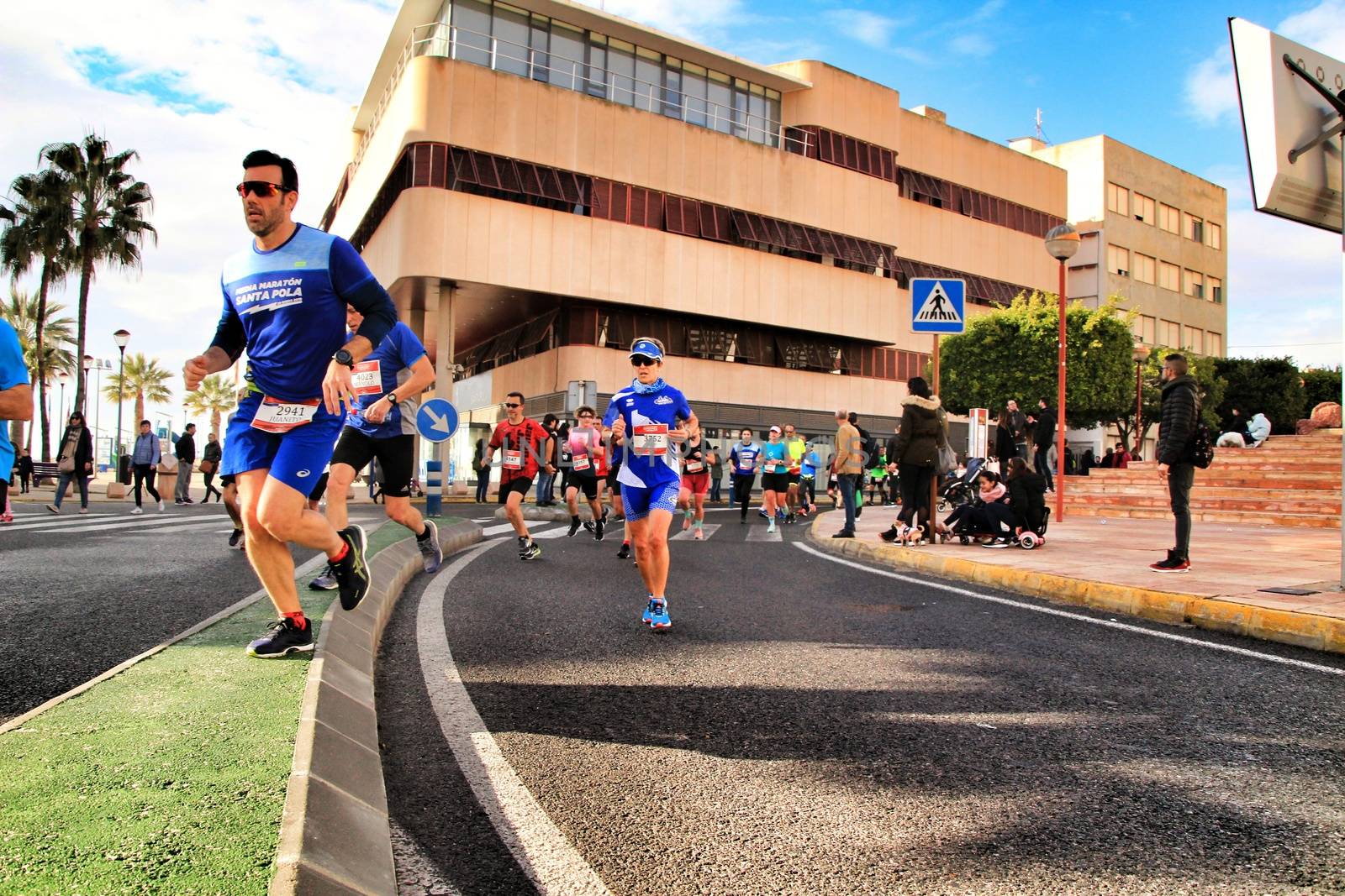 Santa Pola, Spain- January 20, 2019: Runners in the Half Marathon of the fishing village of Santa Pola, province of Alicante, on a sunny day in January
