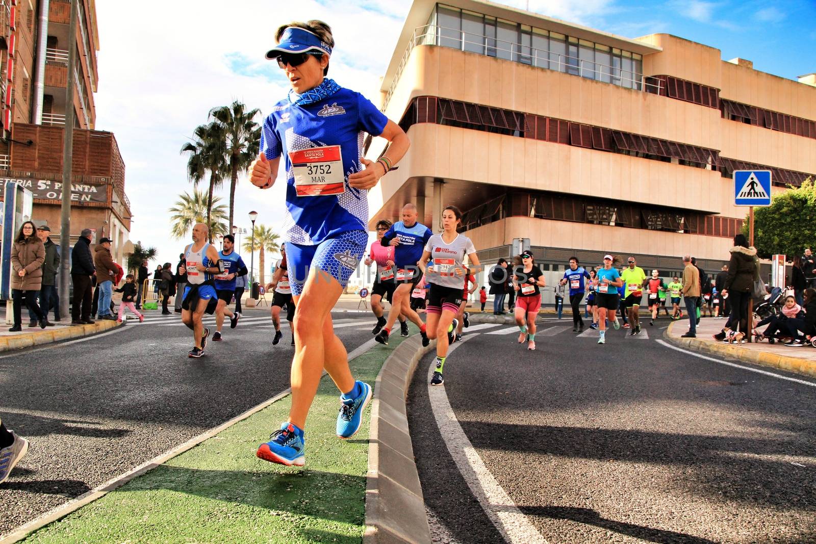 Santa Pola, Spain- January 20, 2019: Runners in the Half Marathon of the fishing village of Santa Pola, province of Alicante, on a sunny day in January