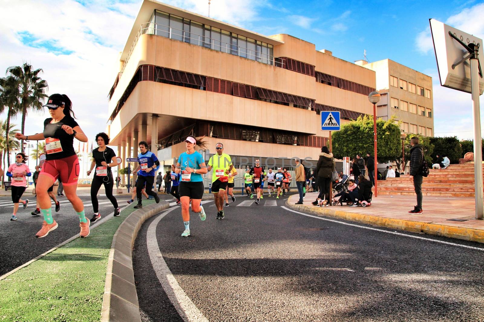 Santa Pola, Spain- January 20, 2019: Runners in the Half Marathon of the fishing village of Santa Pola, province of Alicante, on a sunny day in January