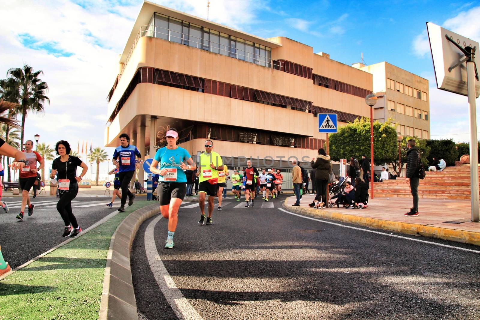 Santa Pola, Spain- January 20, 2019: Runners in the Half Marathon of the fishing village of Santa Pola, province of Alicante, on a sunny day in January