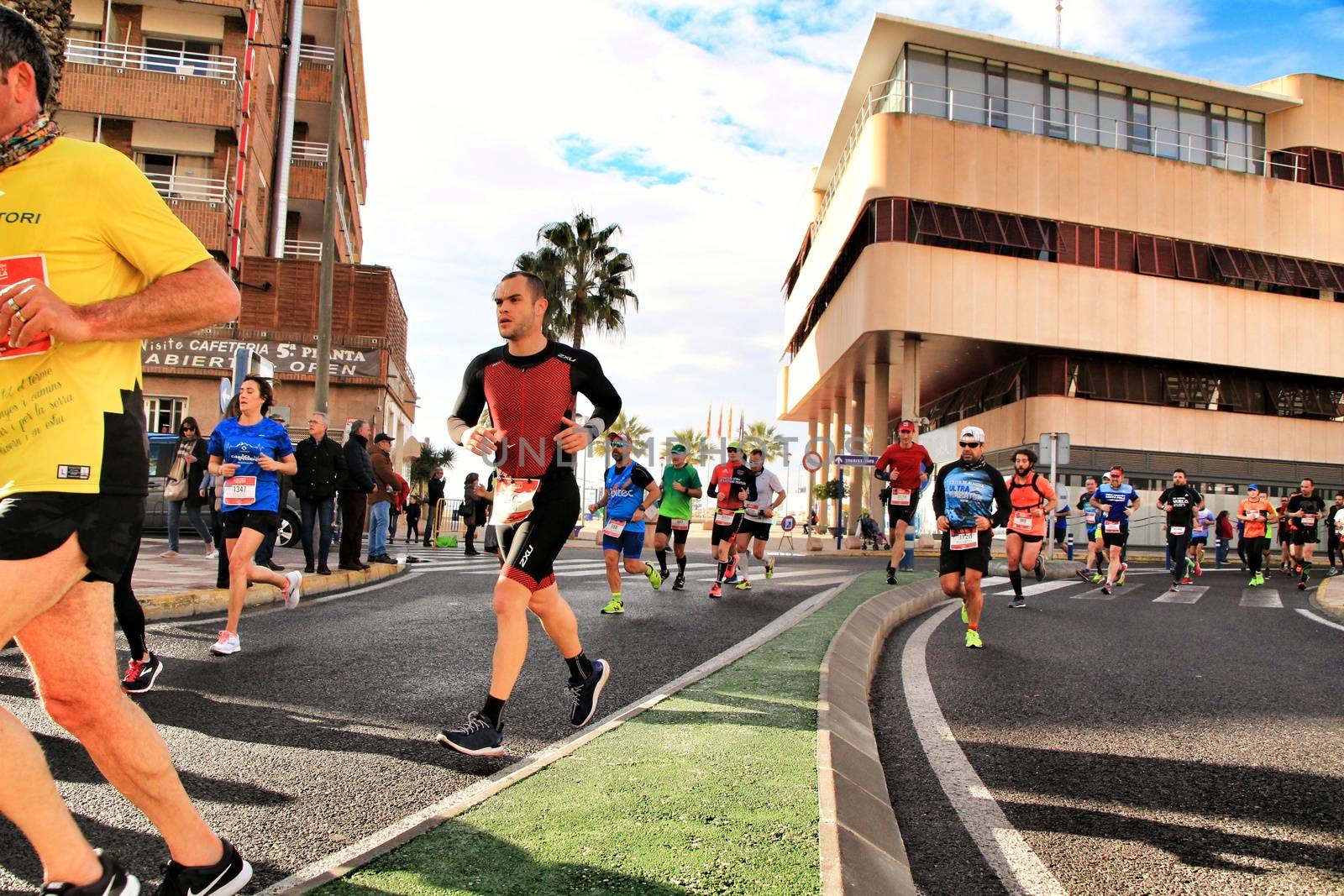 Santa Pola, Spain- January 20, 2019: Runners in the Half Marathon of the fishing village of Santa Pola, province of Alicante, on a sunny day in January