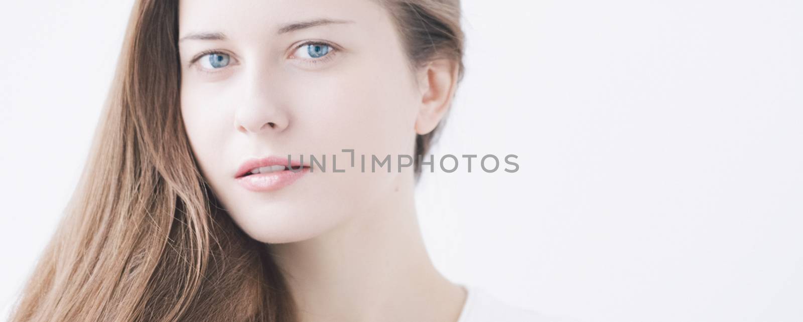 Beauty face portrait of a young woman, natural makeup look, skincare and hair care brand