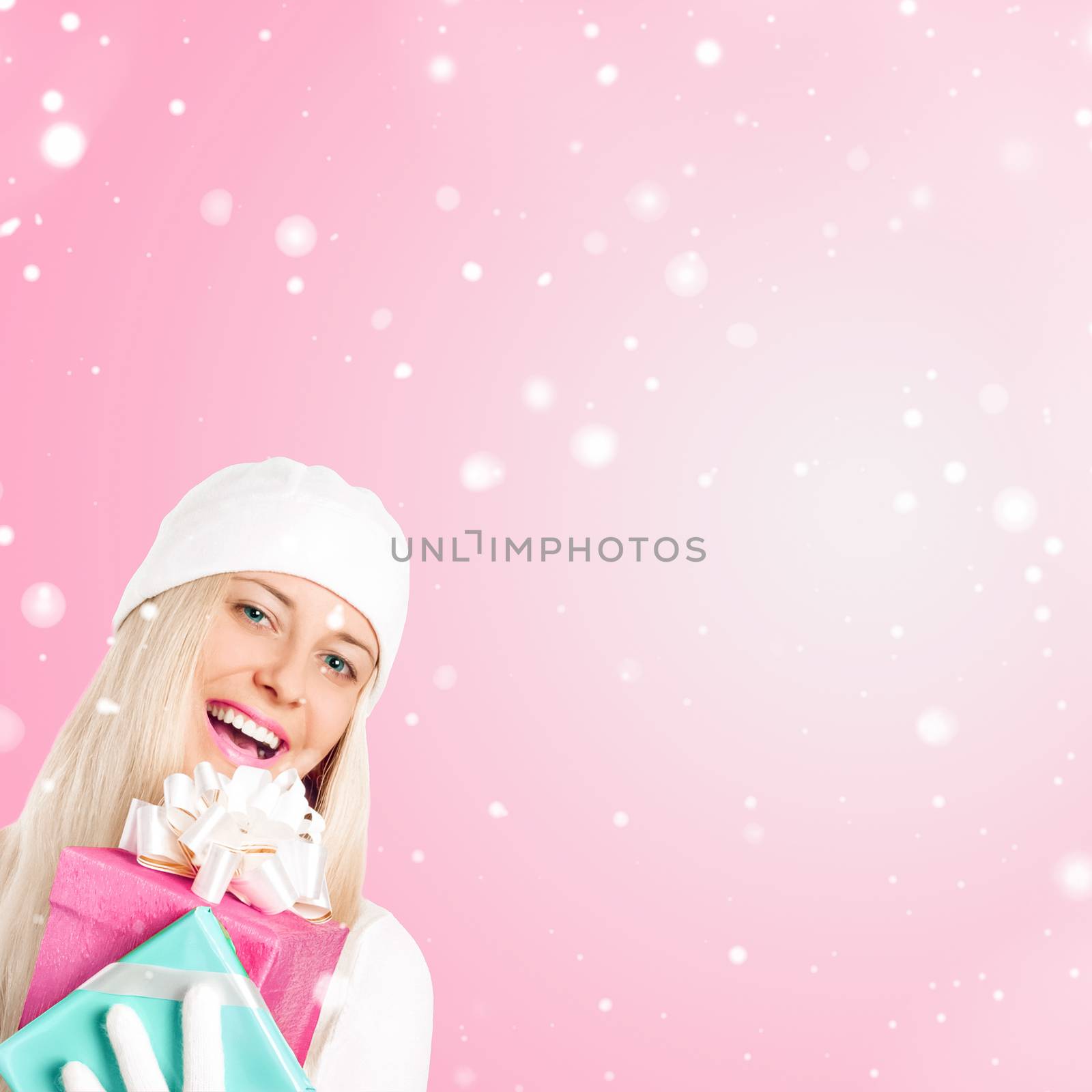 Happy woman holding Christmas gifts, pink background and snow glitter with copyspace, shopping and holidays