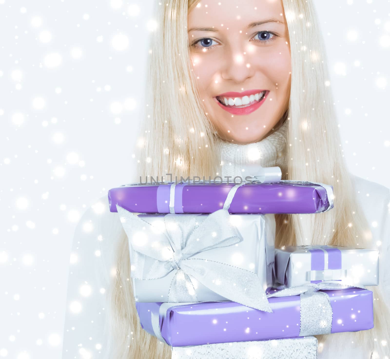 Happy woman holding Christmas gifts, silver background and snow  by Anneleven