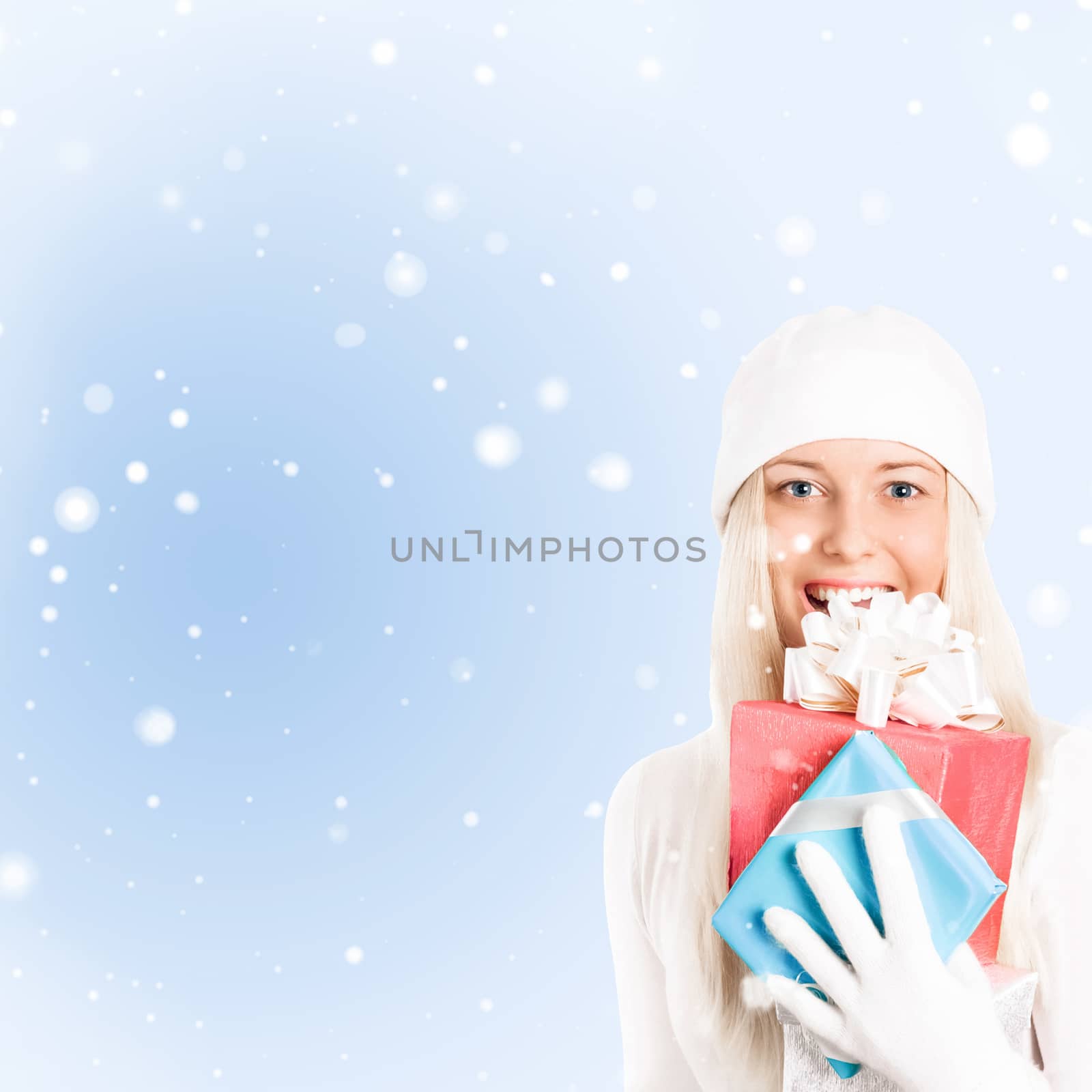 Happy woman holding Christmas gifts, blue background and snow glitter with copyspace, shopping and holidays