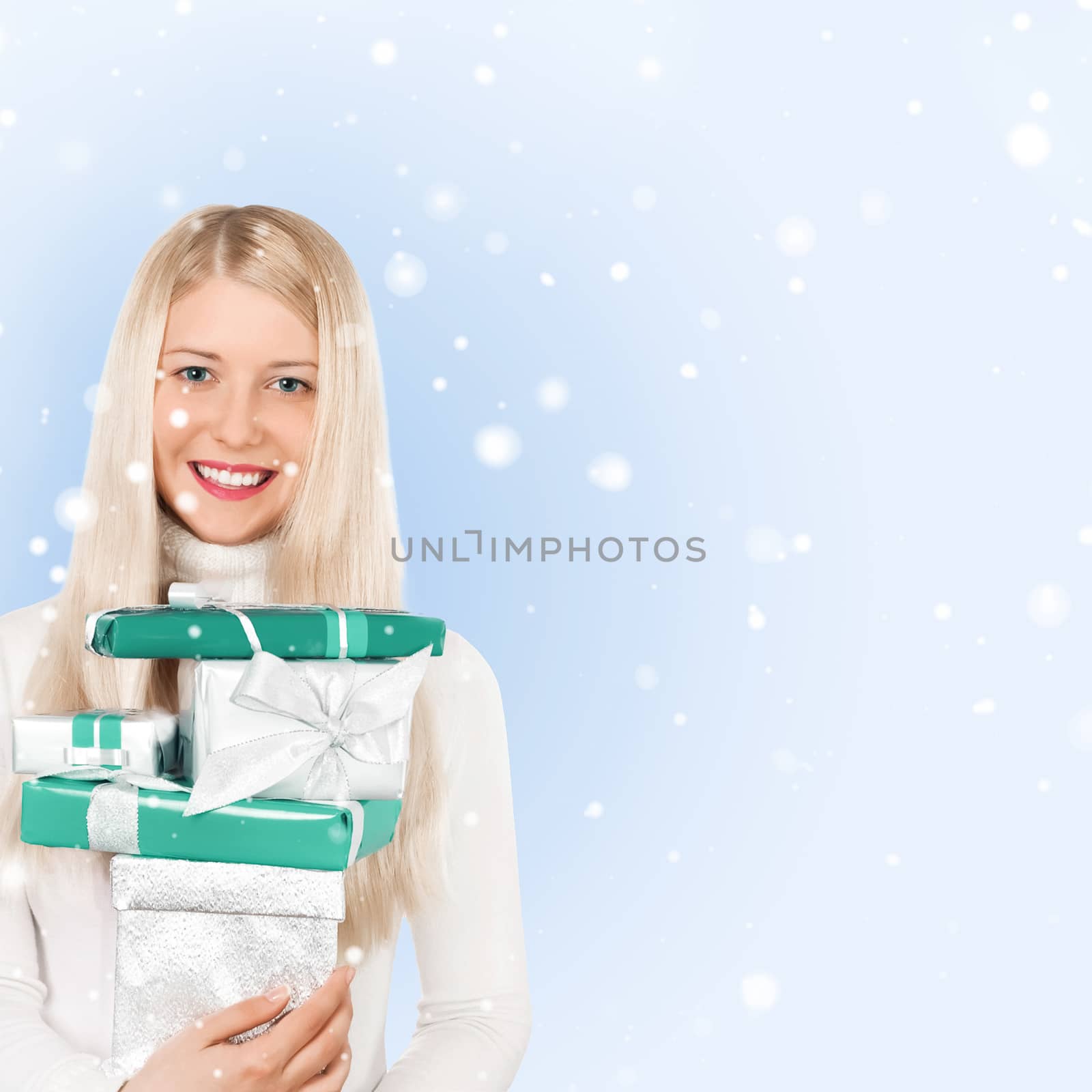 Happy woman holding Christmas gifts, blue background and snow glitter with copyspace, shopping and holidays