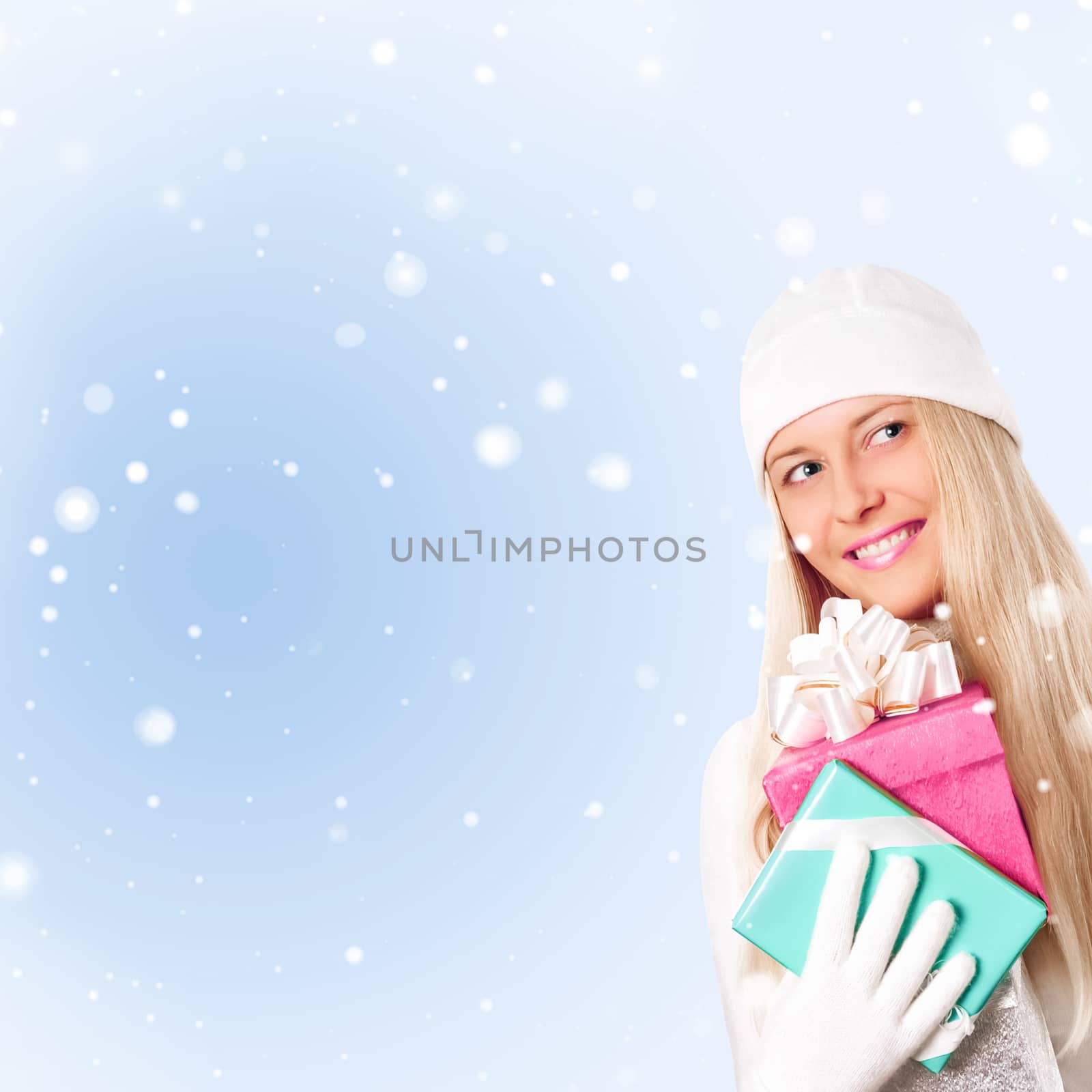 Happy woman holding Christmas gifts, blue background and snow glitter with copyspace, shopping and holidays