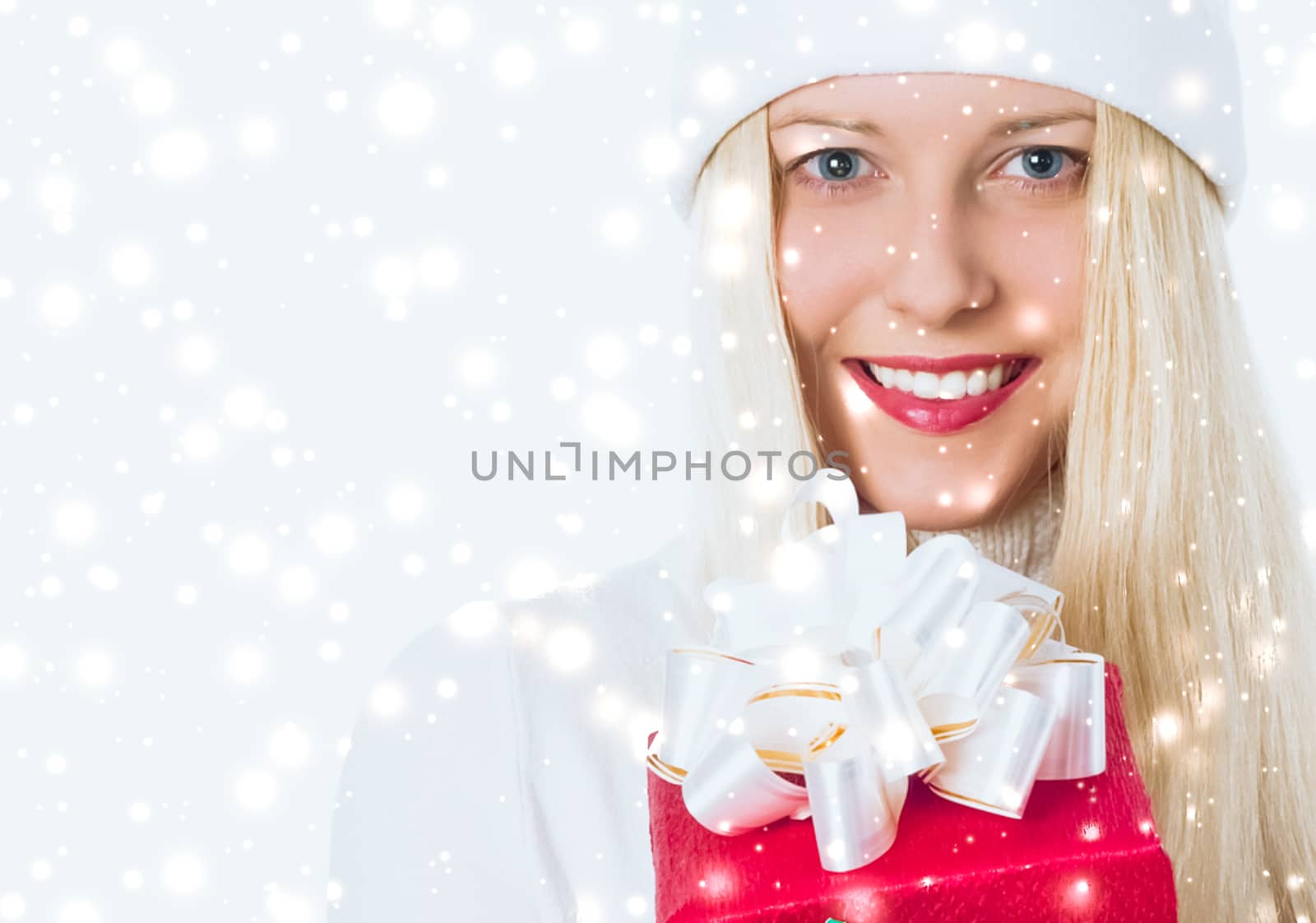 Happy woman holding Christmas gifts, silver background and snow glitter with copyspace, shopping and holidays