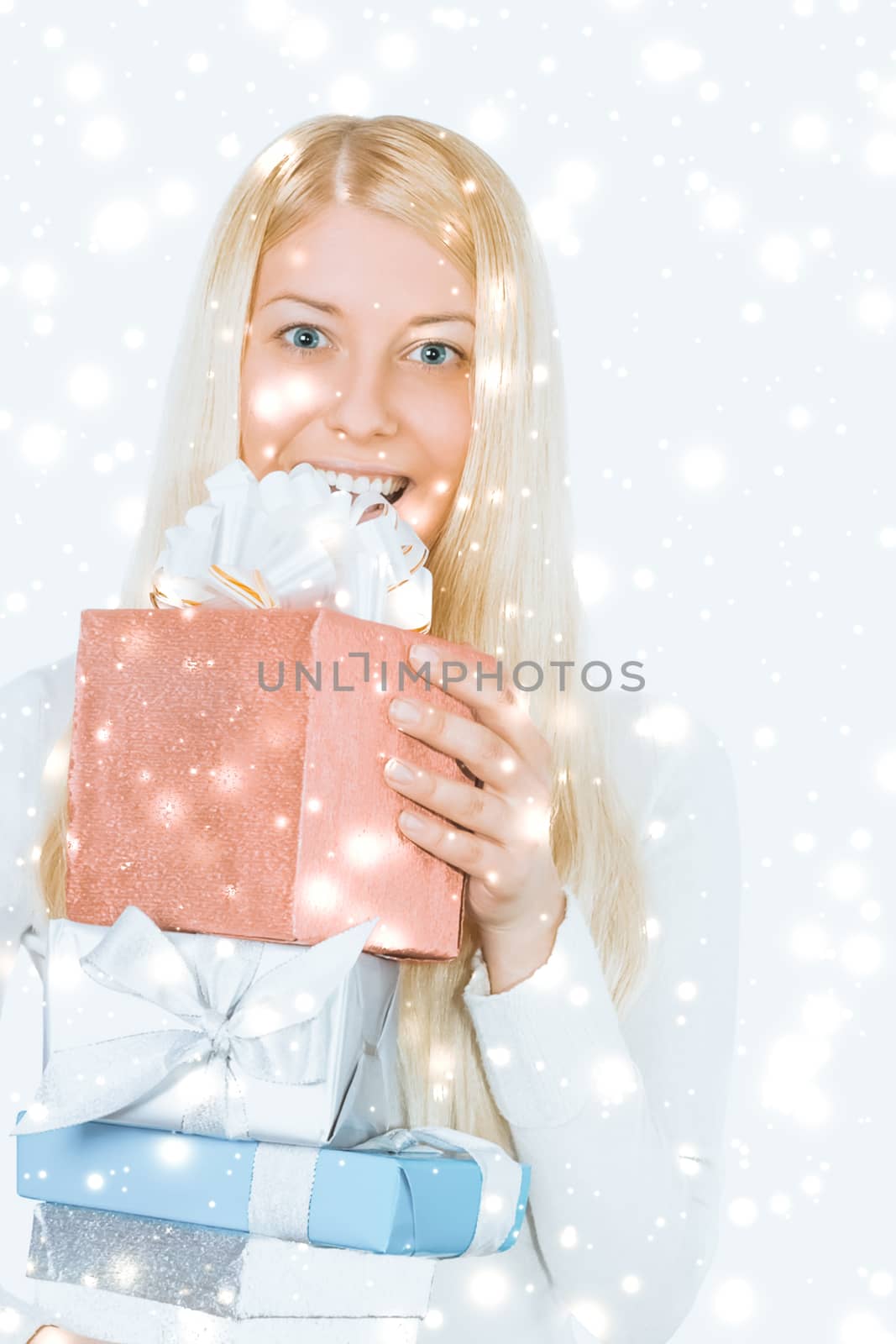 Happy woman holding Christmas gifts, silver background and snow glitter with copyspace, shopping and holidays