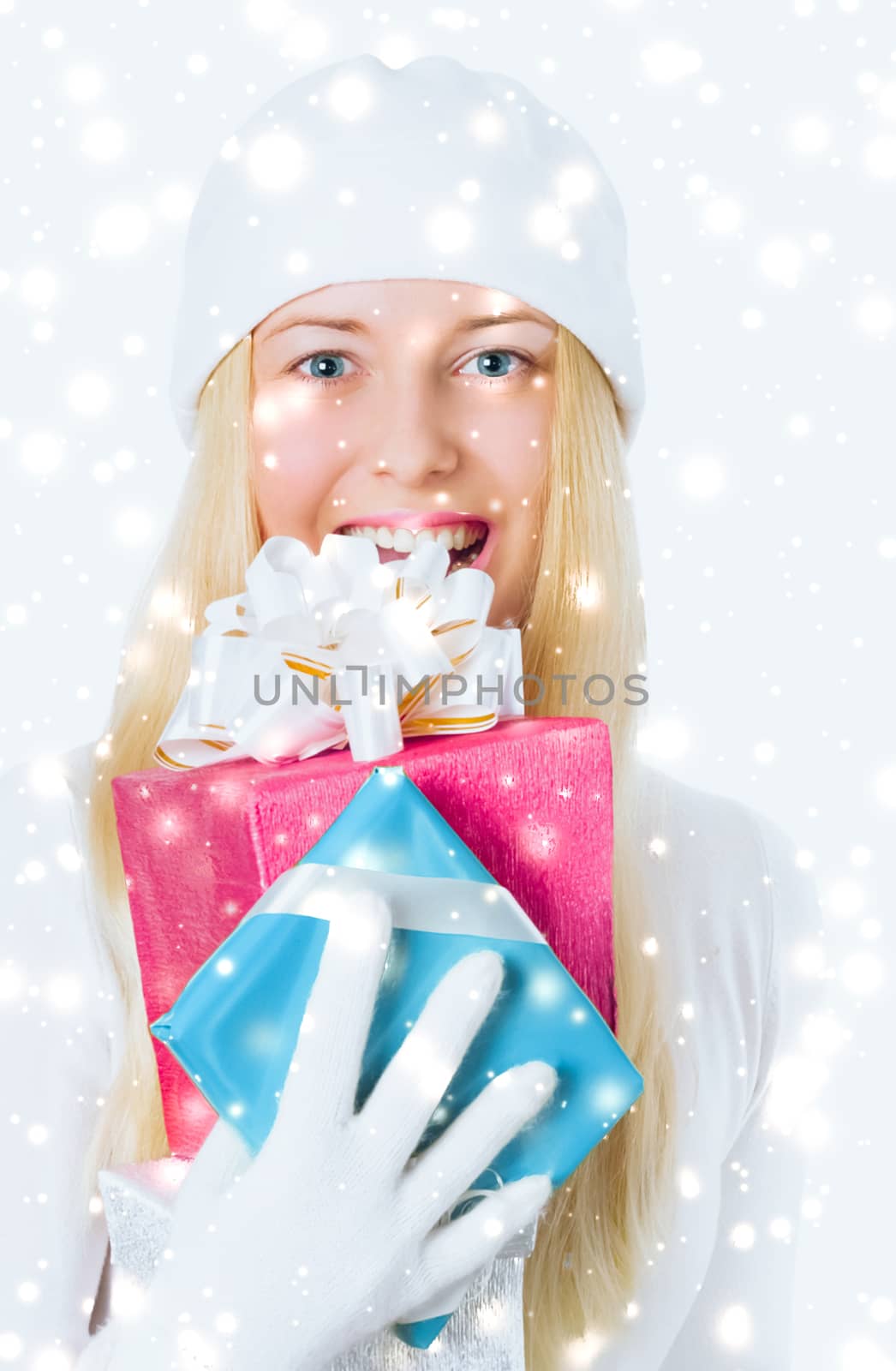 Happy woman holding Christmas gifts, silver background and snow glitter with copyspace, shopping and holidays