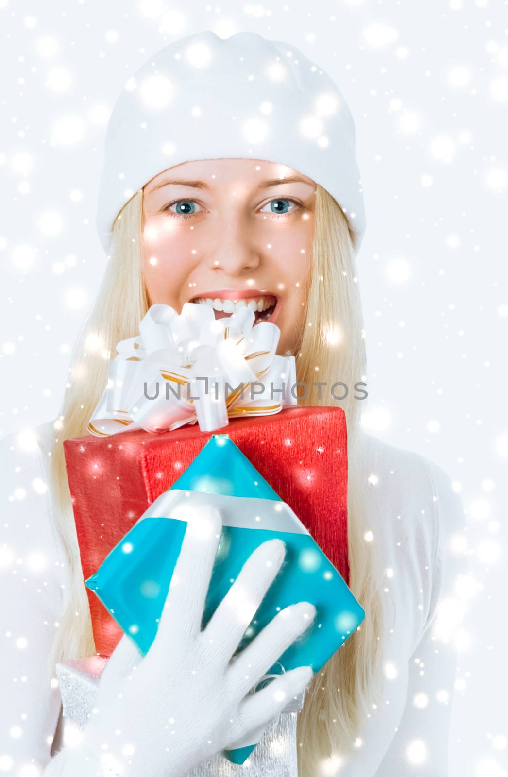 Happy woman holding Christmas gifts, silver background and snow glitter with copyspace, shopping and holidays