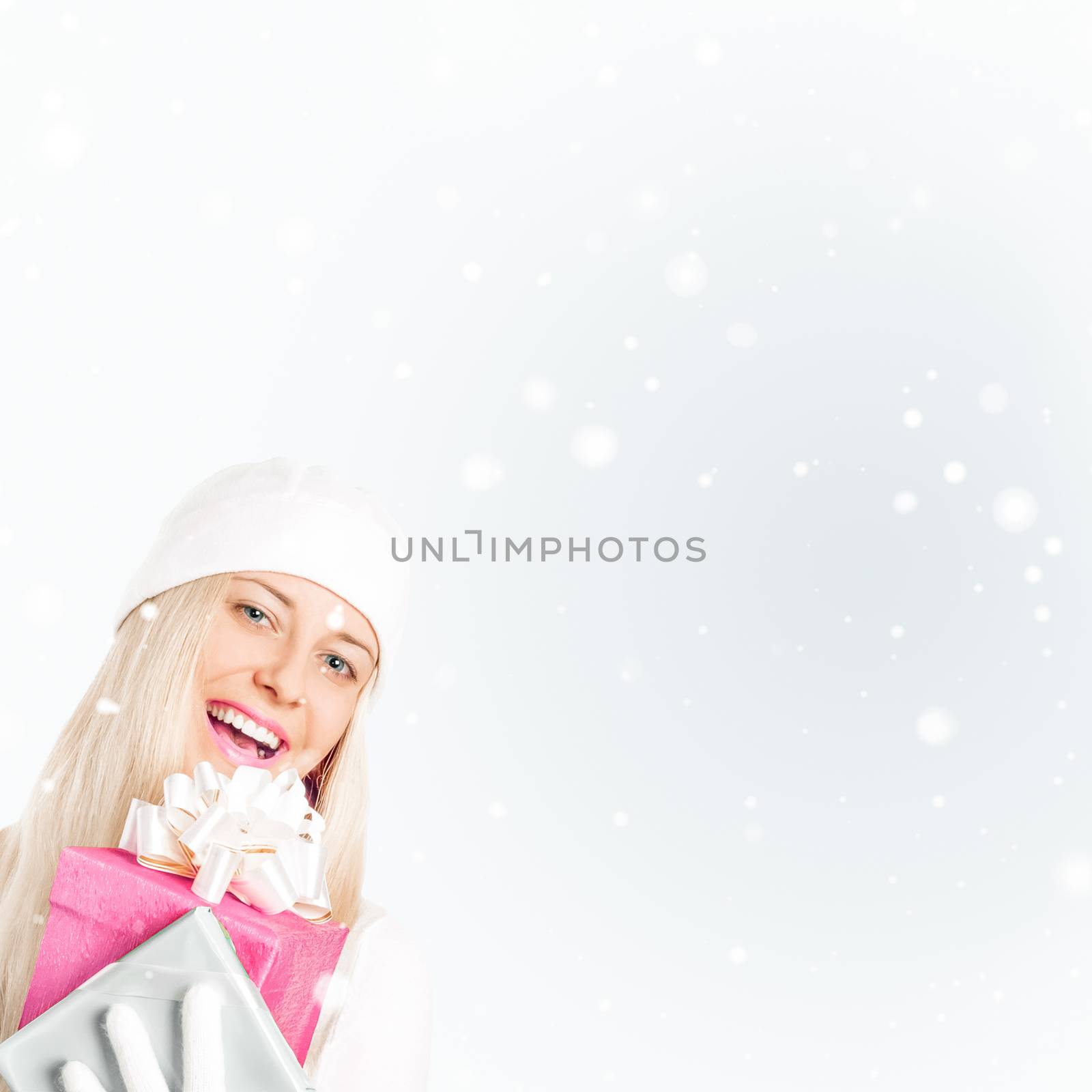 Happy woman holding Christmas gifts, silver background and snow glitter with copyspace, shopping and holidays