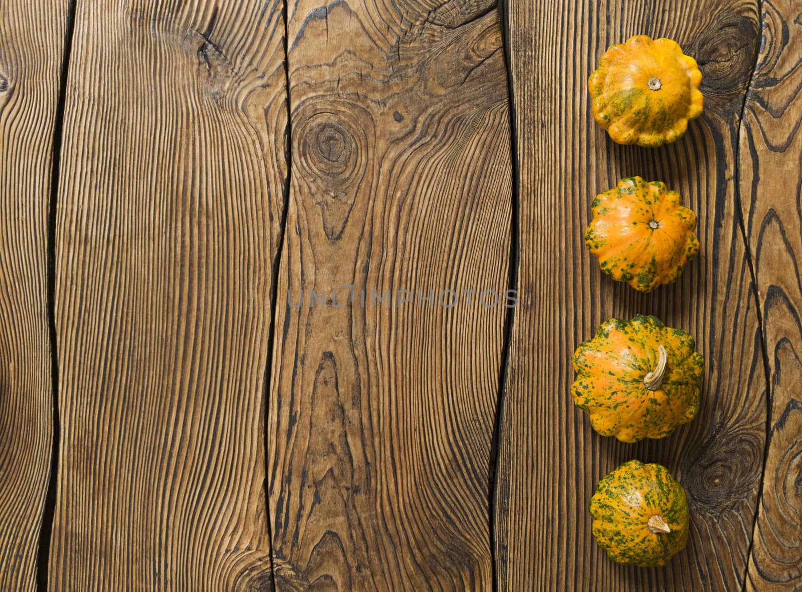 Variety of pumpkins on a wood background. Harvest concept flat lay with copy space.