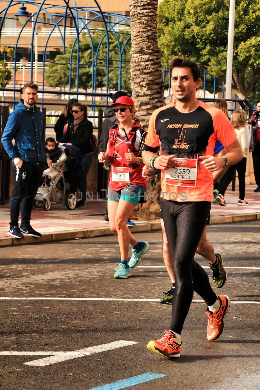 Santa Pola, Spain- January 20, 2019: Runners in the Half Marathon of the fishing village of Santa Pola, province of Alicante, on a sunny day in January