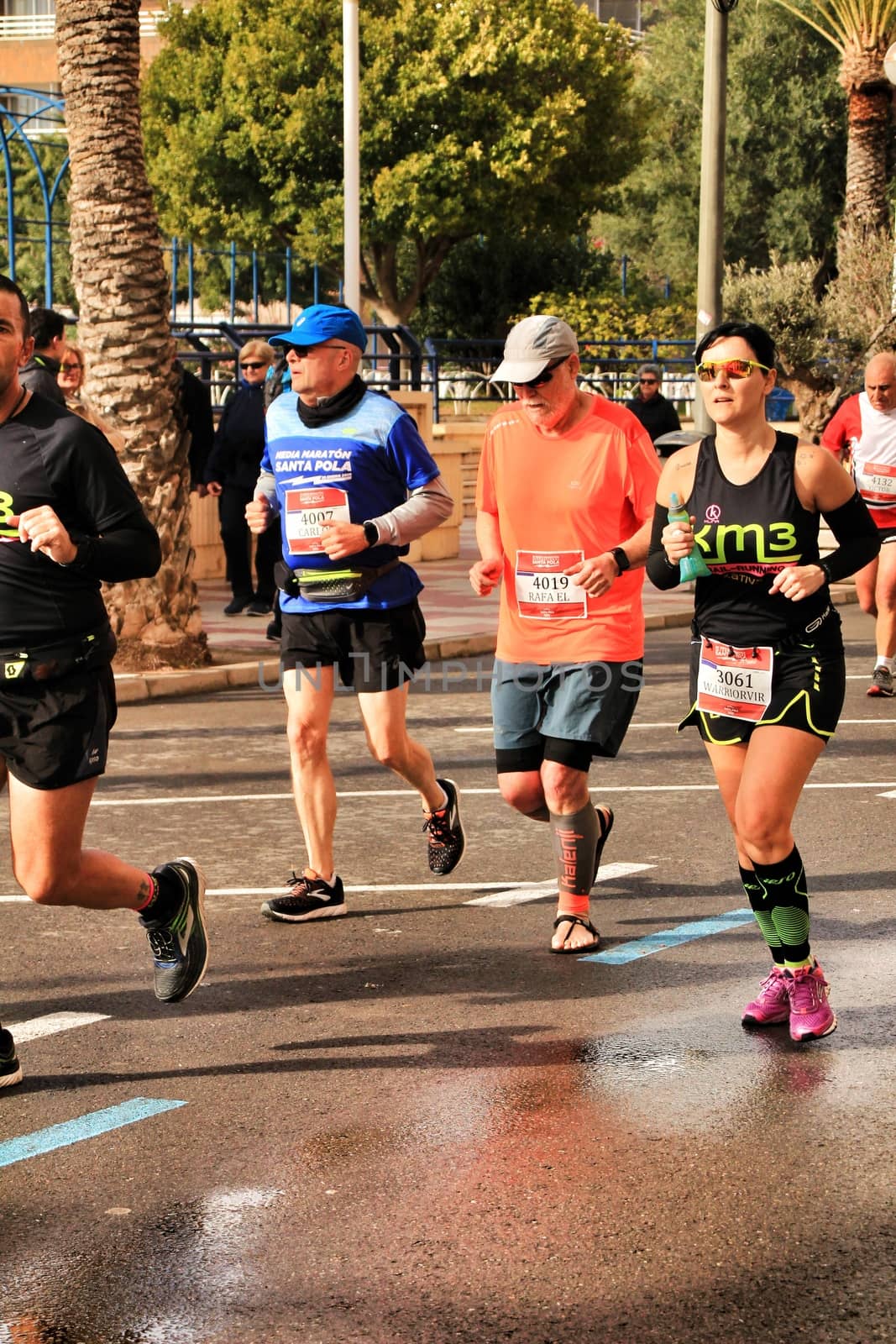 Santa Pola, Spain- January 20, 2019: Runners in the Half Marathon of the fishing village of Santa Pola, province of Alicante, on a sunny day in January