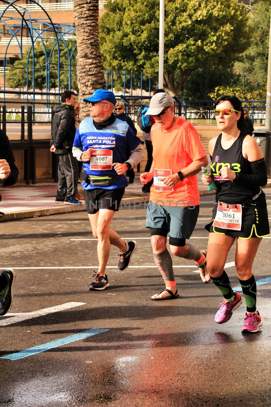 Santa Pola, Spain- January 20, 2019: Runners in the Half Marathon of the fishing village of Santa Pola, province of Alicante, on a sunny day in January