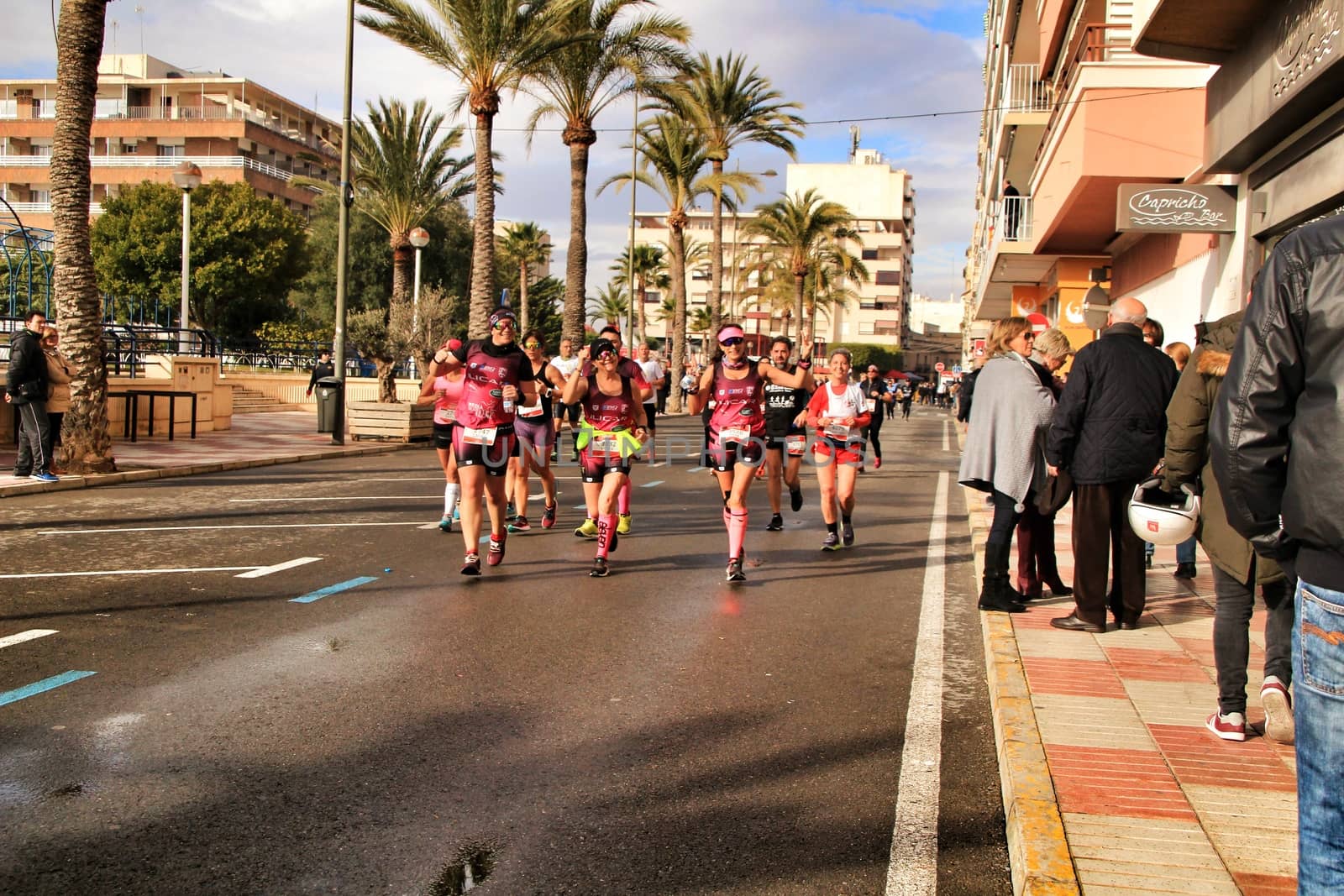 Santa Pola, Spain- January 20, 2019: Runners in the Half Marathon of the fishing village of Santa Pola, province of Alicante, on a sunny day in January
