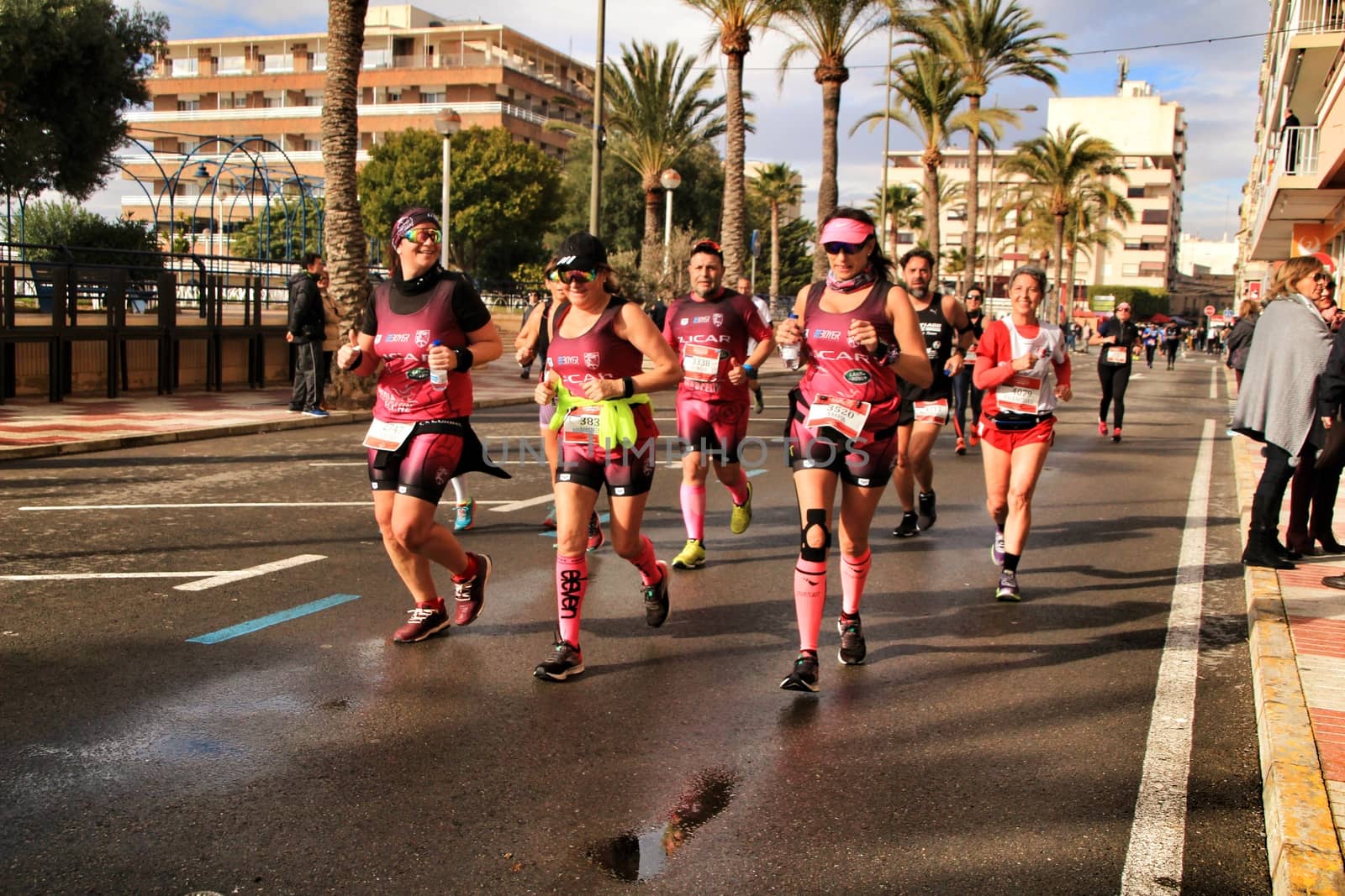 Santa Pola, Spain- January 20, 2019: Runners in the Half Marathon of the fishing village of Santa Pola, province of Alicante, on a sunny day in January