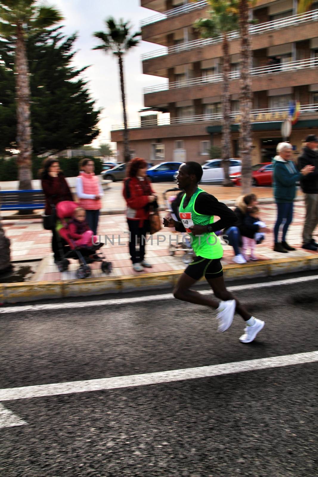 Santa Pola, Spain- January 20, 2019: Runners in the Half Marathon of the fishing village of Santa Pola, province of Alicante, on a sunny day in January