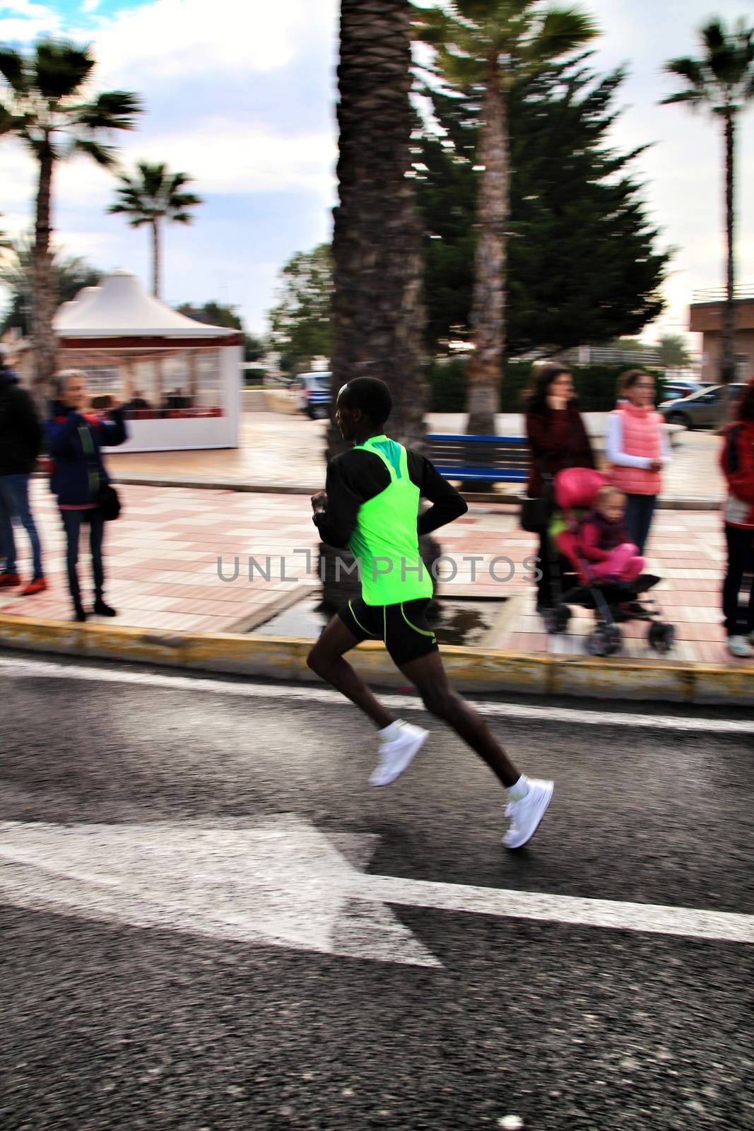 Santa Pola, Spain- January 20, 2019: Runners in the Half Marathon of the fishing village of Santa Pola, province of Alicante, on a sunny day in January