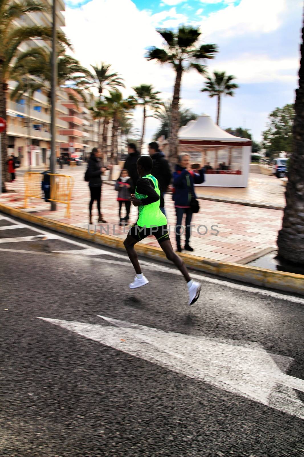 Santa Pola, Spain- January 20, 2019: Runners in the Half Marathon of the fishing village of Santa Pola, province of Alicante, on a sunny day in January
