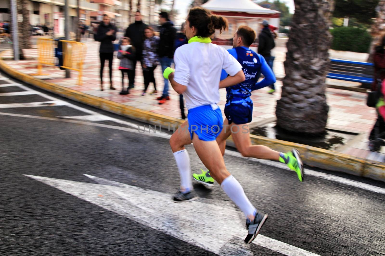 Santa Pola, Spain- January 20, 2019: Runners in the Half Marathon of the fishing village of Santa Pola, province of Alicante, on a sunny day in January