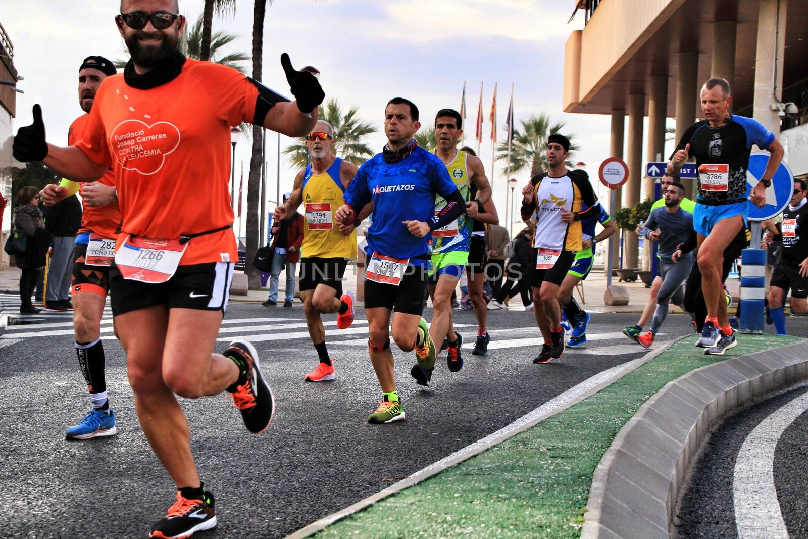 Santa Pola, Spain- January 20, 2019: Runners in the Half Marathon of the fishing village of Santa Pola, province of Alicante, on a sunny day in January