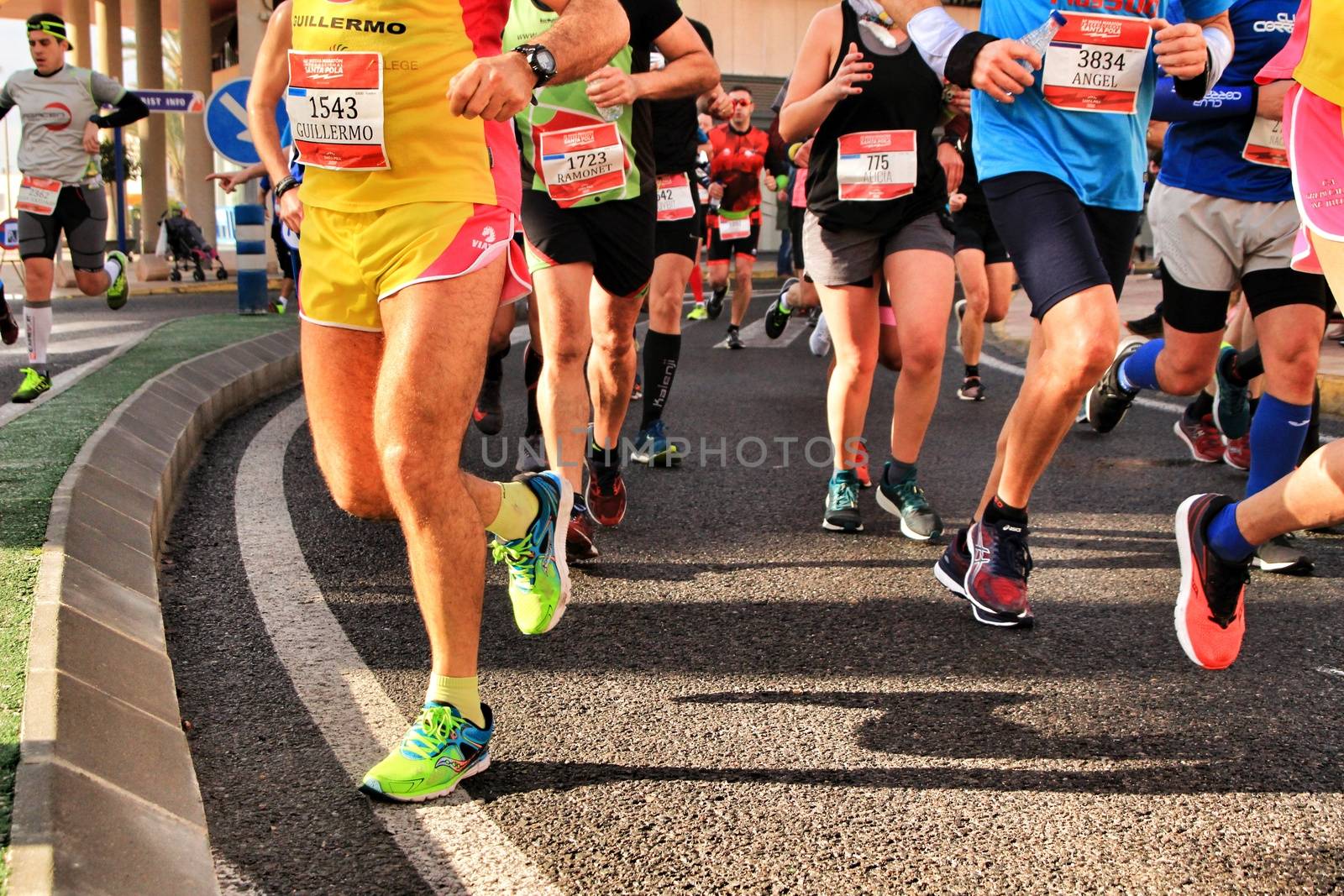 Santa Pola, Spain- January 20, 2019: Runners in the Half Marathon of the fishing village of Santa Pola, province of Alicante, on a sunny day in January